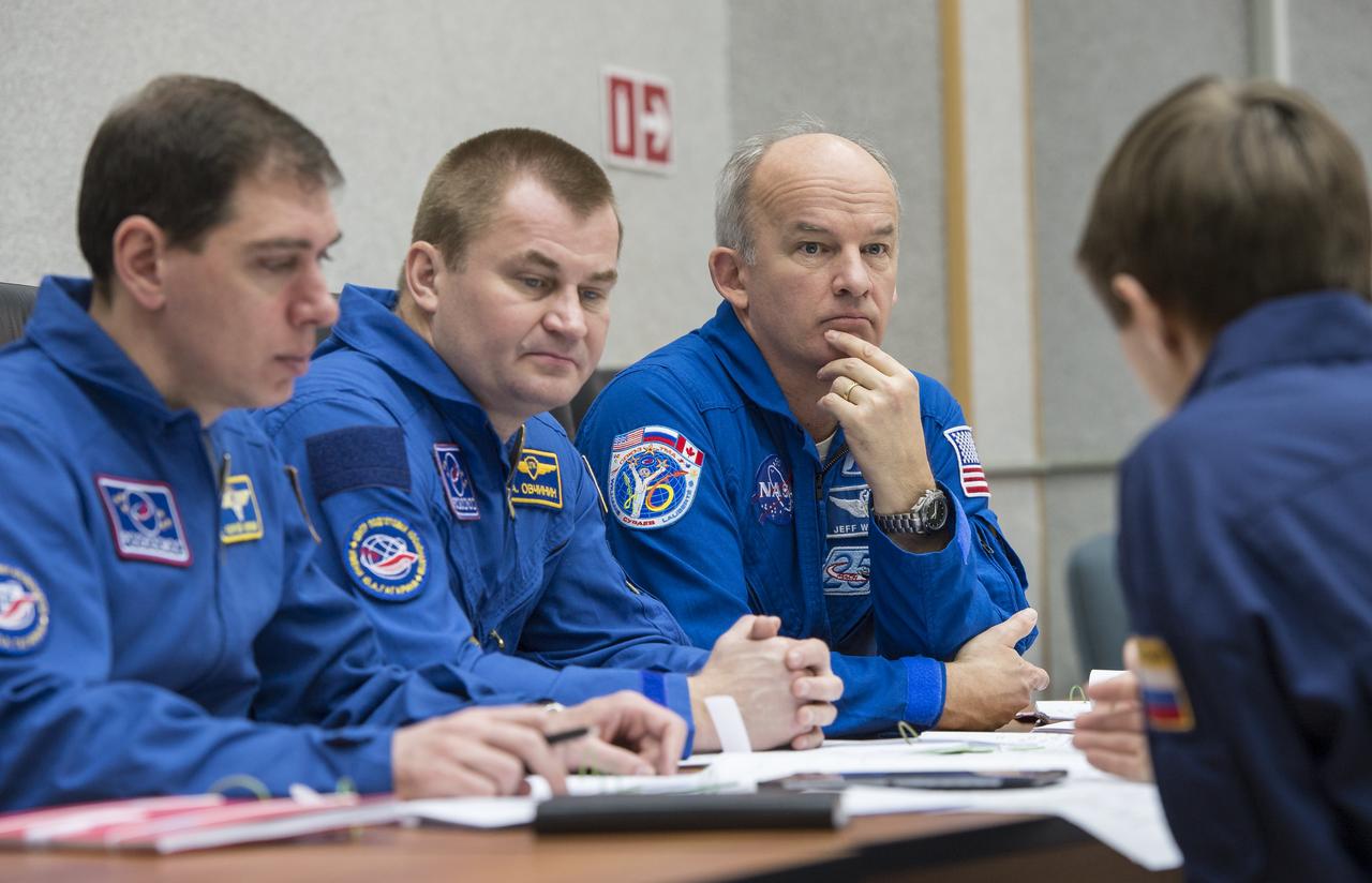 Expedition 43 backup crew members Sergei Volkov, left, and Alexey Ovchinin and of the Russian Federal Space Agency (Roscosmos), center, and NASA Astronaut Jeff Williams attend a training briefing, Saturday, March 21, 2015 at the Cosmonaut Hotel in Baikonur, Kazakhstan. Expedition 43 prime crew members: NASA Astronaut Scott Kelly, and Russian Cosmonauts Gennady Padalka, and Mikhail Kornienko of the Russian Federal Space Agency (Roscosmos) are scheduled to launch to the International Space Station in the Soyuz TMA-16M spacecraft from the Baikonur Cosmodrome in Kazakhstan March 28, Kazakh time (March 27 Eastern time.) As the one-year crew, Kelly and Kornienko will return to Earth on Soyuz TMA-18M in March 2016. Photo Credit: (NASA/Bill Ingalls)