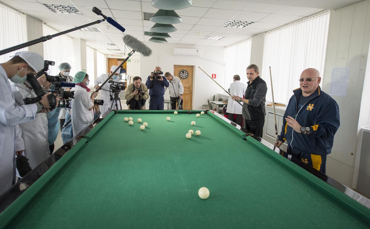 Media document Expedition 43 Russian Cosmonaut Mikhail Kornienko of the Russian Federal Space Agency (Roscosmos), left, and NASA Astronaut Scott Kelly, right, as they play billiards during media day, Saturday, March 21, 2015, Baikonur, Kazakhstan. Kelly, and Russian Cosmonauts Gennady Padalka, and Mikhail Kornienko of Roscosmos are scheduled to launch to the International Space Station in the Soyuz TMA-16M spacecraft from the Baikonur Cosmodrome in Kazakhstan March 28, Kazakh time (March 27 Eastern time.) As the one-year crew, Kelly and Kornienko will return to Earth on Soyuz TMA-18M in March 2016. Photo Credit: (NASA/Bill Ingalls)