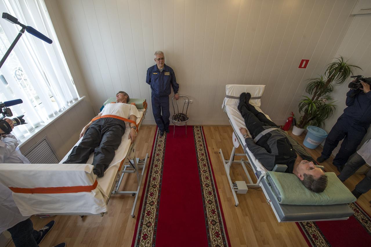 Expedition 43 Russian Cosmonauts Gennady Padalka, left, and Mikhail Kornienko of the Russian Federal Space Agency (Roscosmos) take part the tilt table training during media day, Saturday, March 21, 2015, Baikonur, Kazakhstan. Padalka, Kornienko, and Expedition 43 NASA Astronaut Scott Kelly are scheduled to launch to the International Space Station in the Soyuz TMA-16M spacecraft from the Baikonur Cosmodrome in Kazakhstan March 28, Kazakh time (March 27 Eastern time.) As the one-year crew, Kelly and Kornienko will return to Earth on Soyuz TMA-18M in March 2016. Photo Credit: (NASA/Bill Ingalls)