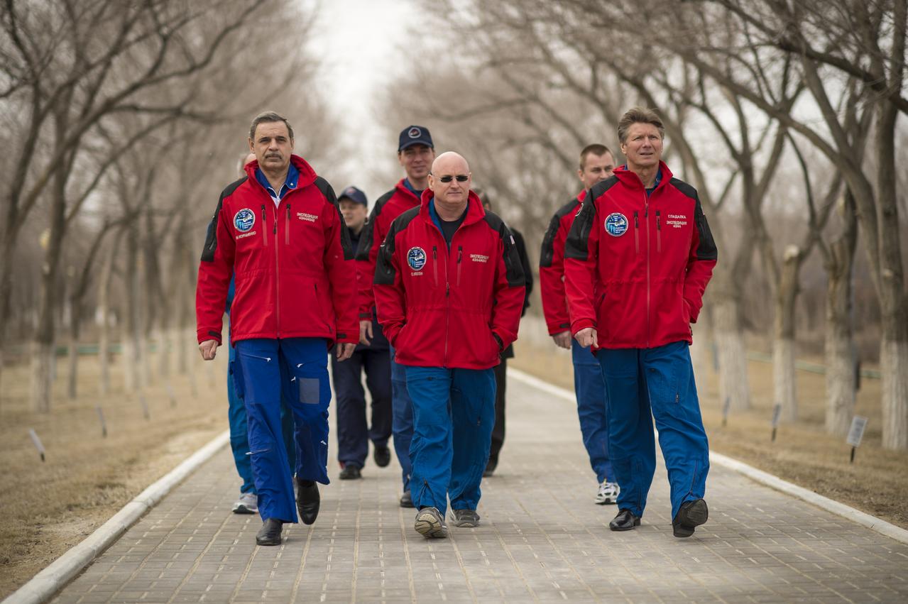 Expedition 43 prime crew members: NASA Astronaut Scott Kelly, and Russian Cosmonauts Gennady Padalka, and Mikhail Kornienko of the Russian Federal Space Agency (Roscosmos), and backup crew members Sergei Volkov, and Alexey Ovchinin and of Roscosmos, and NASA Astronaut Jeff Williams walk along the Avenue of the Cosmonauts where two long rows of trees are all marked with the name and year of the crew member who planted them starting from Yuri Gagarin's tree, Saturday, March 21, 2015, Baikonur, Kazakhstan. Expedition 43 NASA Astronaut Scott Kelly, and Russian Cosmonauts Gennady Padalka, and Mikhail Kornienko of the Russian Federal Space Agency (Roscosmos) are scheduled to launch to the International Space Station in the Soyuz TMA-16M spacecraft from the Baikonur Cosmodrome in Kazakhstan March 28, Kazakh time (March 27 Eastern time.) As the one-year crew, Kelly and Kornienko will return to Earth on Soyuz TMA-18M in March 2016. Photo Credit: (NASA/Bill Ingalls)