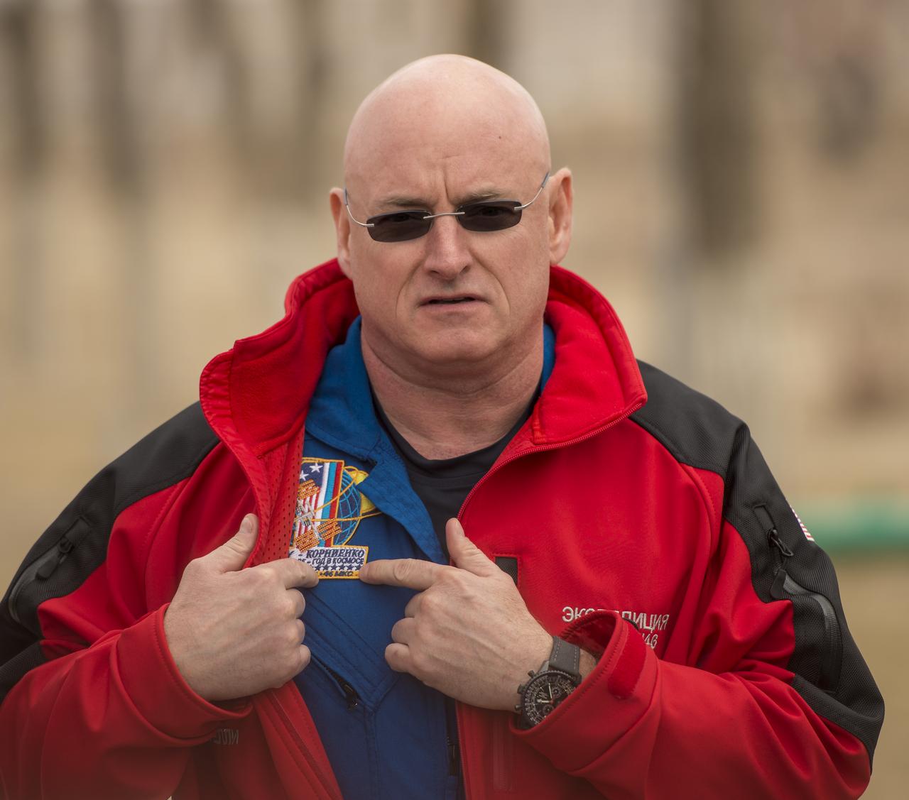 Expedition 43 NASA Astronaut Scott Kelly describes his One-Year mission patch to members of the press during media day, Saturday, March 21, 2015 at the Cosmonaut Hotel in Baikonur, Kazakhstan. Kelly, and Russian Cosmonauts Mikhail Kornienko, and Gennady Padalka of the Russian Federal Space Agency (Roscosmos) are scheduled to launch to the International Space Station in the Soyuz TMA-16M spacecraft from the Baikonur Cosmodrome in Kazakhstan March 28, Kazakh time (March 27 Eastern time.) As the one-year crew, Kelly and Kornienko will return to Earth on Soyuz TMA-18M in March 2016. Photo Credit: (NASA/Bill Ingalls)