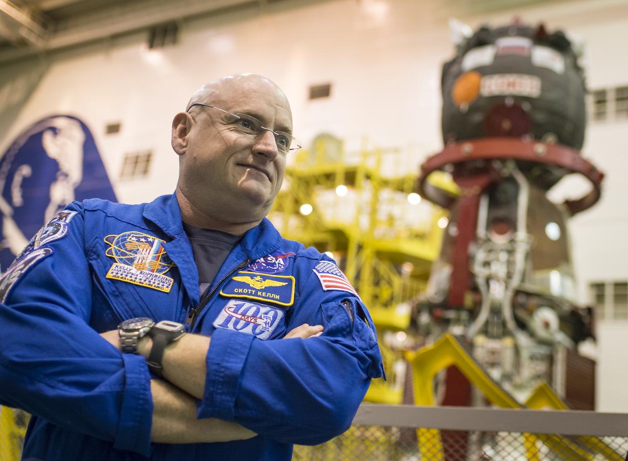 Expedition 43 NASA Astronaut Scott Kelly waits to climb the scaffolding to access the Soyuz TMA-16M spacecraft for his final check with fellow crew members Russian Cosmonauts Gennady Padalka, and Mikhail Kornienko of the Russian Federal Space Agency (Roscosmos), Monday, March 23, 2015 at the Baikonur Cosmodrome in Kazakhstan. Kelly, Kornienko, and Padalka are scheduled to launch to the International Space Station in the Soyuz TMA-16M spacecraft from the Baikonur Cosmodrome in Kazakhstan March 28, Kazakh time (March 27 Eastern time.) As the one-year crew, Kelly and Kornienko will return to Earth on Soyuz TMA-18M in March 2016. Photo Credit: (NASA/Bill Ingalls)
