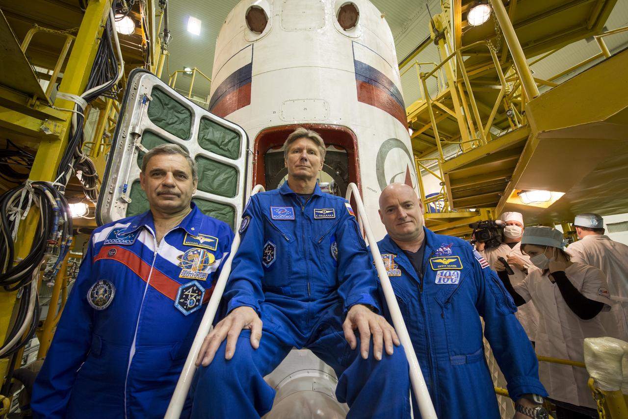 Expedition 43 Russian Cosmonauts Mikhail Kornienko, left, and Gennady Padalka of the Russian Federal Space Agency (Roscosmos), and NASA Astronaut Scott Kelly, right, pose for a photograph on the stairs leading into the Soyuz TMA-16M spacecraft during the final check of the spacecraft, Monday, March 23, 2015 at the Baikonur Cosmodrome in Kazakhstan. Kelly, Kornienko, and Padalka are scheduled to launch to the International Space Station in the Soyuz TMA-16M spacecraft from the Baikonur Cosmodrome in Kazakhstan March 28, Kazakh time (March 27 Eastern time.) As the one-year crew, Kelly and Kornienko will return to Earth on Soyuz TMA-18M in March 2016. Photo Credit: (NASA/Bill Ingalls)