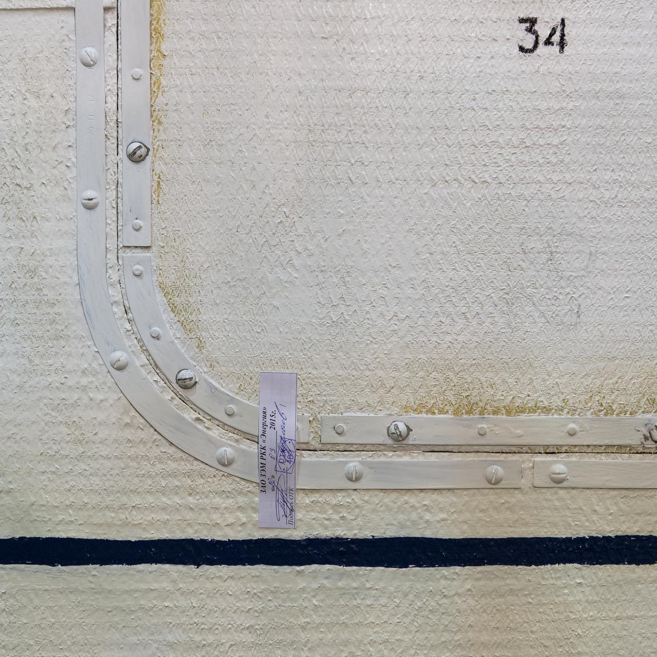 A Soyuz TMA-16M spacecraft access panel and inspection sticker is seen on the fairing during the final check of the spacecraft with Expedition 43 NASA Astronaut Scott Kelly, Russian Cosmonauts Mikhail Kornienko, and Gennady Padalka of the Russian Federal Space Agency (Roscosmos) inside, Monday, March 23, 2015 at the Baikonur Cosmodrome in Kazakhstan. Kelly, Kornienko, and Padalka are scheduled to launch to the International Space Station in the Soyuz TMA-16M spacecraft from the Baikonur Cosmodrome in Kazakhstan March 28, Kazakh time (March 27 Eastern time.) As the one-year crew, Kelly and Kornienko will return to Earth on Soyuz TMA-18M in March 2016. Photo Credit: (NASA/Bill Ingalls)