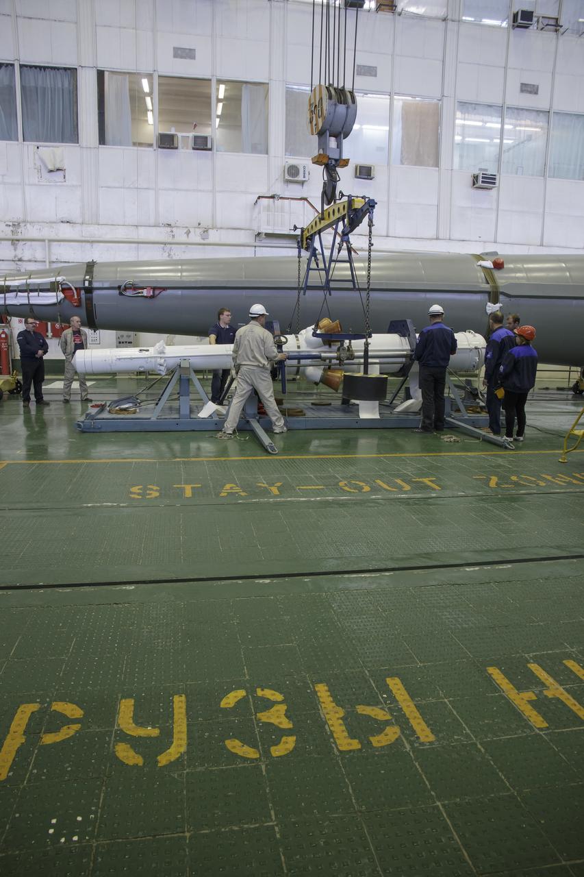 The Soyuz rocket and Soyuz TMA-16M spacecraft are assembled at Building 112 on the Baikonur Cosmodrome on Tuesday, March 24, 2015 in Baikonur, Kazakhstan. NASA Astronaut Scott Kelly, and Russian Cosmonauts Mikhail Kornienko, and Gennady Padalka of the Russian Federal Space Agency (Roscosmos) are scheduled to launch to the International Space Station in the Soyuz TMA-16M spacecraft from the Baikonur Cosmodrome in Kazakhstan March 28, Kazakh time (March 27 Eastern time.) As the one-year crew, Kelly and Kornienko will return to Earth on Soyuz TMA-18M in March 2016. Photo Credit: (NASA/Victor Zelentsov)