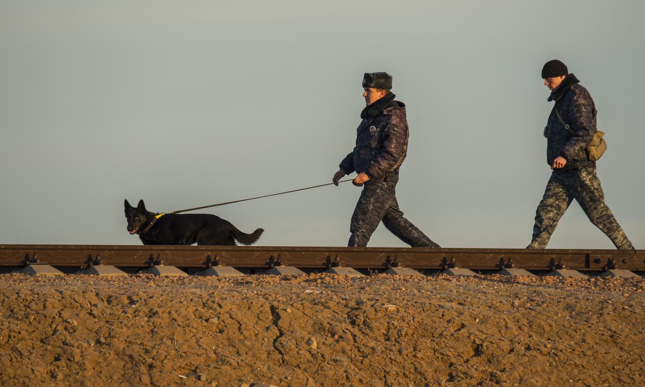 A Security team walks the railroad tracks ahead of the Soyuz TMA-16M spacecraft as it is rolled out by train to the launch pad at the Baikonur Cosmodrome, Kazakhstan, Wednesday, March 25, 2015. NASA Astronaut Scott Kelly, and Russian Cosmonauts Mikhail Kornienko, and Gennady Padalka of the Russian Federal Space Agency (Roscosmos) are scheduled to launch to the International Space Station in the Soyuz TMA-16M spacecraft from the Baikonur Cosmodrome in Kazakhstan March 28, Kazakh time (March 27 Eastern time.) As the one-year crew, Kelly and Kornienko will return to Earth on Soyuz TMA-18M in March 2016.  Photo Credit (NASA/Bill Ingalls)
