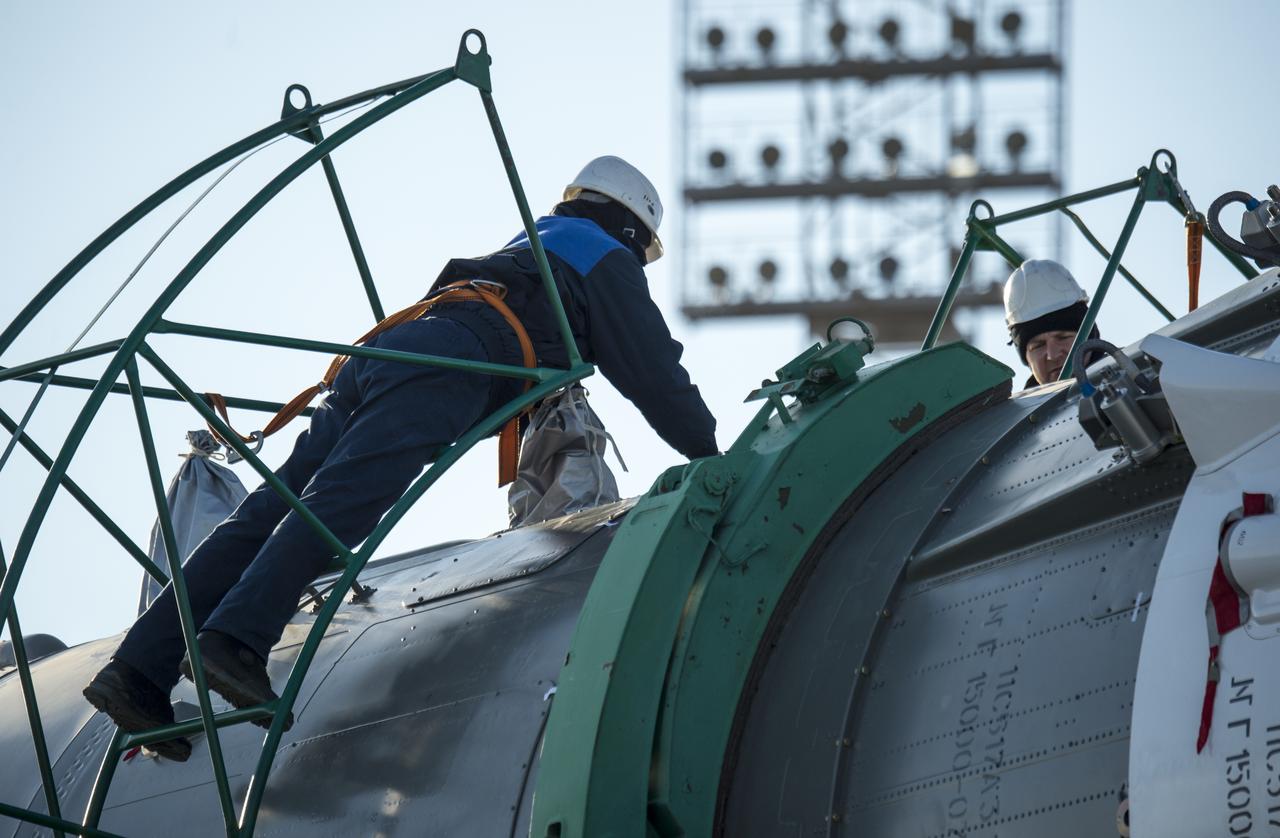 Technicians work to disengage the Soyuz TMA-16M spacecraft from the train that rolled it out to the launch pad at the Baikonur Cosmodrome, Kazakhstan, Wednesday, March 25, 2015. NASA Astronaut Scott Kelly, and Russian Cosmonauts Mikhail Kornienko, and Gennady Padalka of the Russian Federal Space Agency (Roscosmos) are scheduled to launch to the International Space Station in the Soyuz TMA-16M spacecraft from the Baikonur Cosmodrome in Kazakhstan March 28, Kazakh time (March 27 Eastern time.) As the one-year crew, Kelly and Kornienko will return to Earth on Soyuz TMA-18M in March 2016.  Photo Credit (NASA/Bill Ingalls)