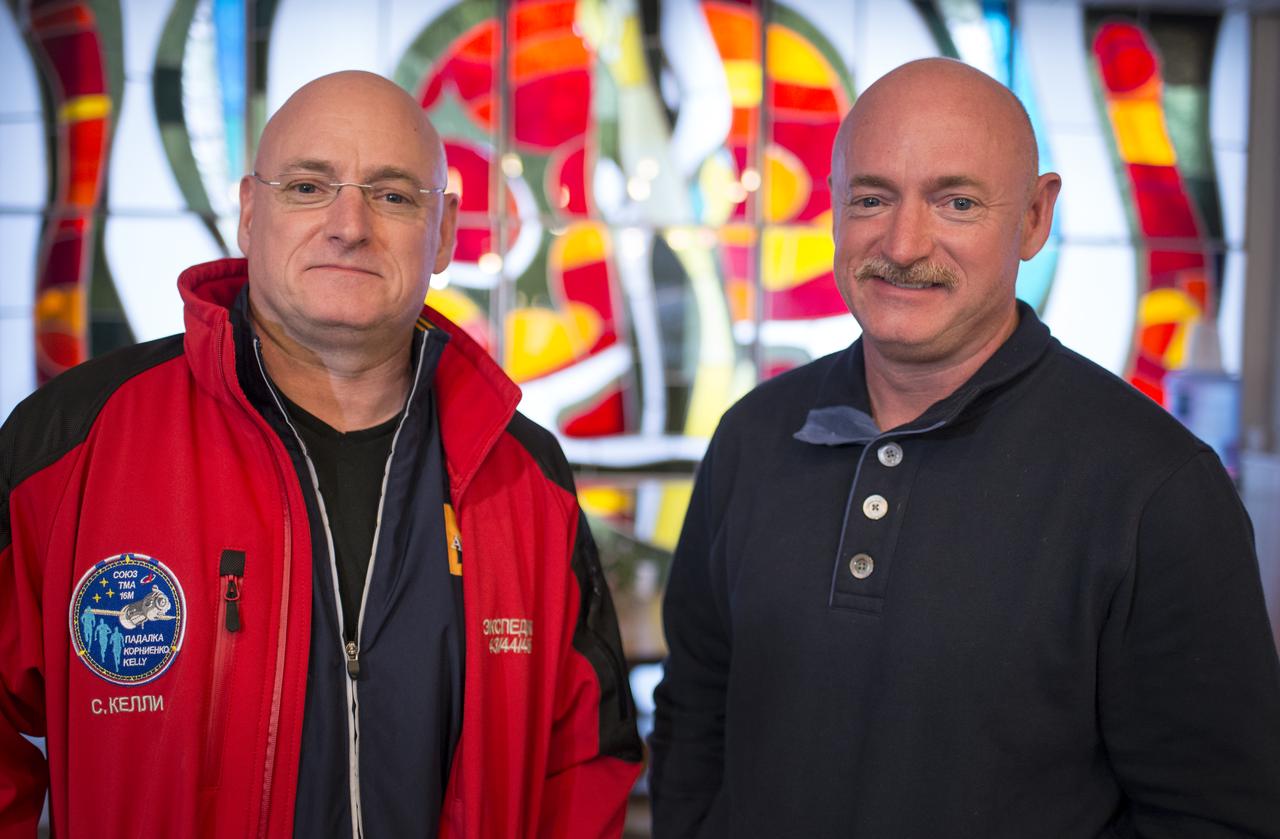 Expedition 43 NASA Astronaut Scott Kelly, left, and his identical twin brother Mark Kelly, pose for a photograph Thursday, March 26, 2015 at the Cosmonaut Hotel in Baikonur, Kazakhstan. Scott Kelly, and Russian Cosmonauts Mikhail Kornienko, and Gennady Padalka of the Russian Federal Space Agency (Roscosmos) are scheduled to launch to the International Space Station in the Soyuz TMA-16M spacecraft from the Baikonur Cosmodrome in Kazakhstan March 28, Kazakh time (March 27 Eastern time.) As the one-year crew, Kelly and Kornienko will return to Earth on Soyuz TMA-18M in March 2016.  Photo Credit (NASA/Bill Ingalls)