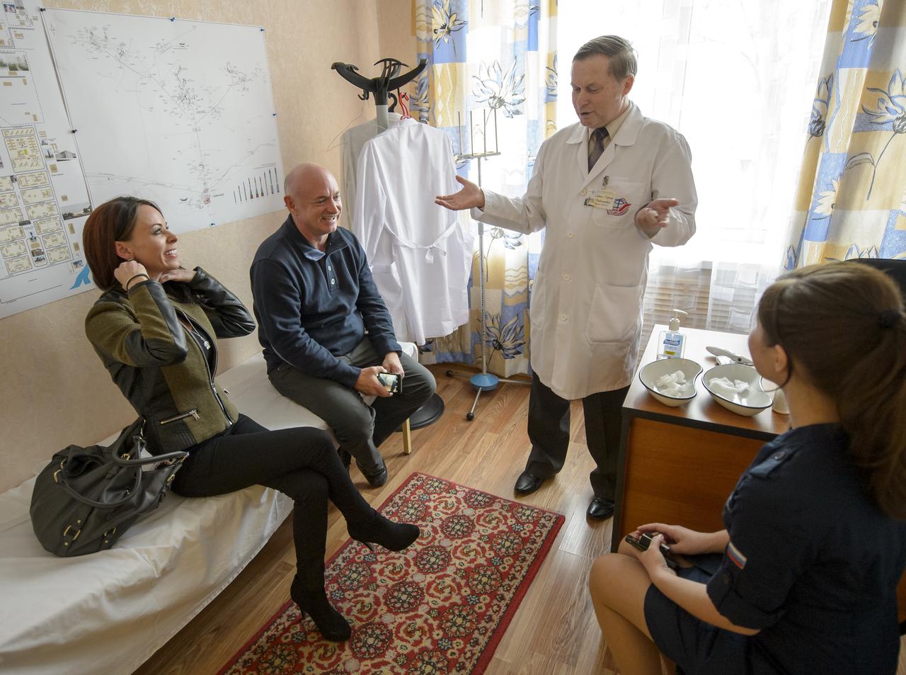 Expedition 43 NASA Astronaut Scott Kelly's girlfriend, Amiko Kauderer, and Kelly's twin brother, retired NASA Astronaut Mark Kelly, meet with Gagarin Cosmonaut Training Center (GCTC) Chief Epidemiologist Sergei Savin to be medically cleared to visit with Scott Thursday, March 26, 2015 at the Cosmonaut Hotel in Baikonur, Kazakhstan. Mark Kelly, who flew four space shuttle missions and commanded the final flight of space shuttle Endeavour, will participate in biomedical studies on the ground while his twin is on board the orbiting laboratory. Scott Kelly, Russian cosmonauts Gennady Padalka, and Mikhail Kornienko of the Russian Federal Space Agency (Roscosmos) launched to the International Space Station in the Soyuz TMA-16M spacecraft from the Baikonur Cosmodrome in Kazakhstan March 28, Kazakh time (March 27 Eastern time.) As the one-year crew, Kelly and Kornienko will return to Earth on Soyuz TMA-18M in March 2016.  Photo Credit (NASA/Bill Ingalls)