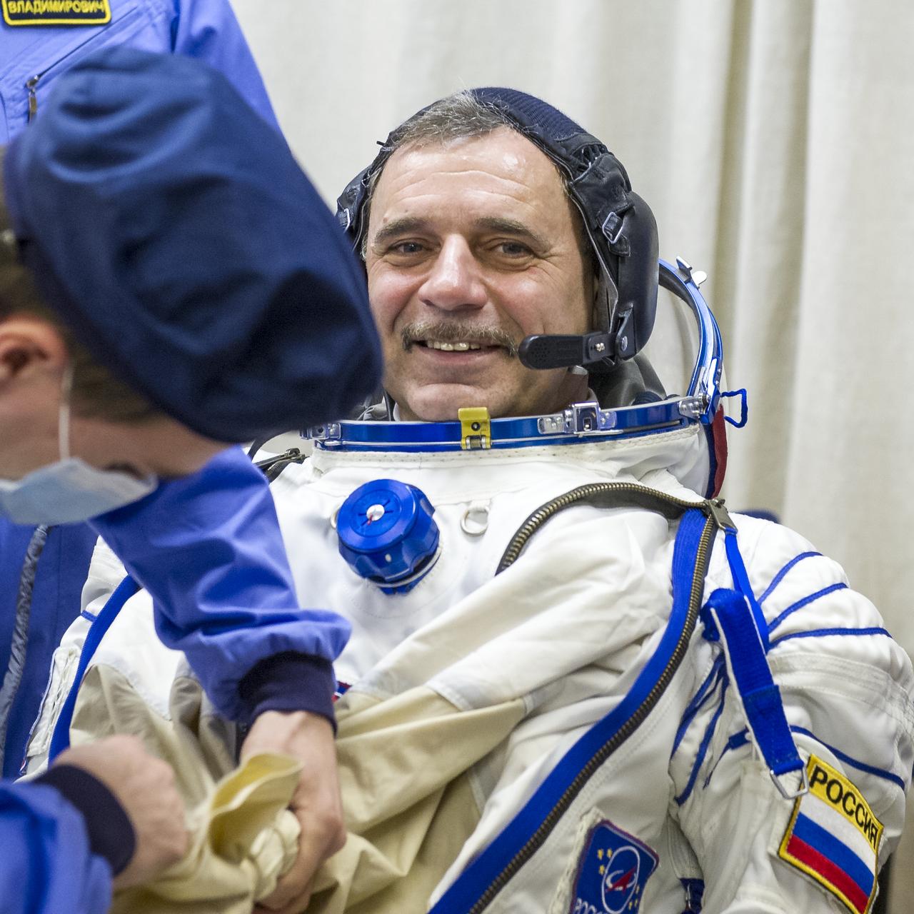Expedition 43 Russian Cosmonaut Mikhail Kornienko of the Russian Federal Space Agency (Roscosmos) dons his Russian sokol suit ahead of his launch onboard the Soyuz TMA-16M spacecraft to the International Space Station with fellow crew mates, NASA Astronaut Scott Kelly, and Russian Cosmonaut Gennady Padalka of Roscosmos Friday, March 27, 2015 in Baikonor, Kazakhstan. As the one-year crew, Kelly and Kornienko will return to Earth on Soyuz TMA-18M in March 2016.  Photo Credit: (NASA/GCTC/Andrey Shelepin)