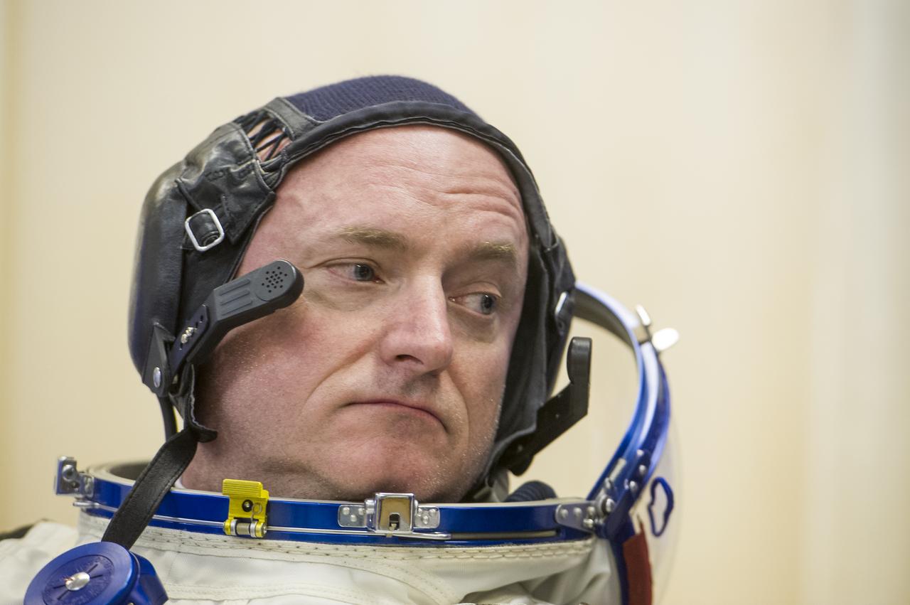 Expedition 43 NASA Astronaut Scott Kelly dons his Russian sokol suit ahead of his launch onboard the Soyuz TMA-16M spacecraft to the International Space Station with fellow crew mates, Russian Cosmonauts Gennady Padalka, and Mikhail Kornienko of the Russian Federal Space Agency (Roscosmos) Friday, March 27, 2015 in Baikonor, Kazakhstan. As the one-year crew, Kelly and Kornienko will return to Earth on Soyuz TMA-18M in March 2016.  Photo Credit: (NASA/GCTC/Andrey Shelepin)