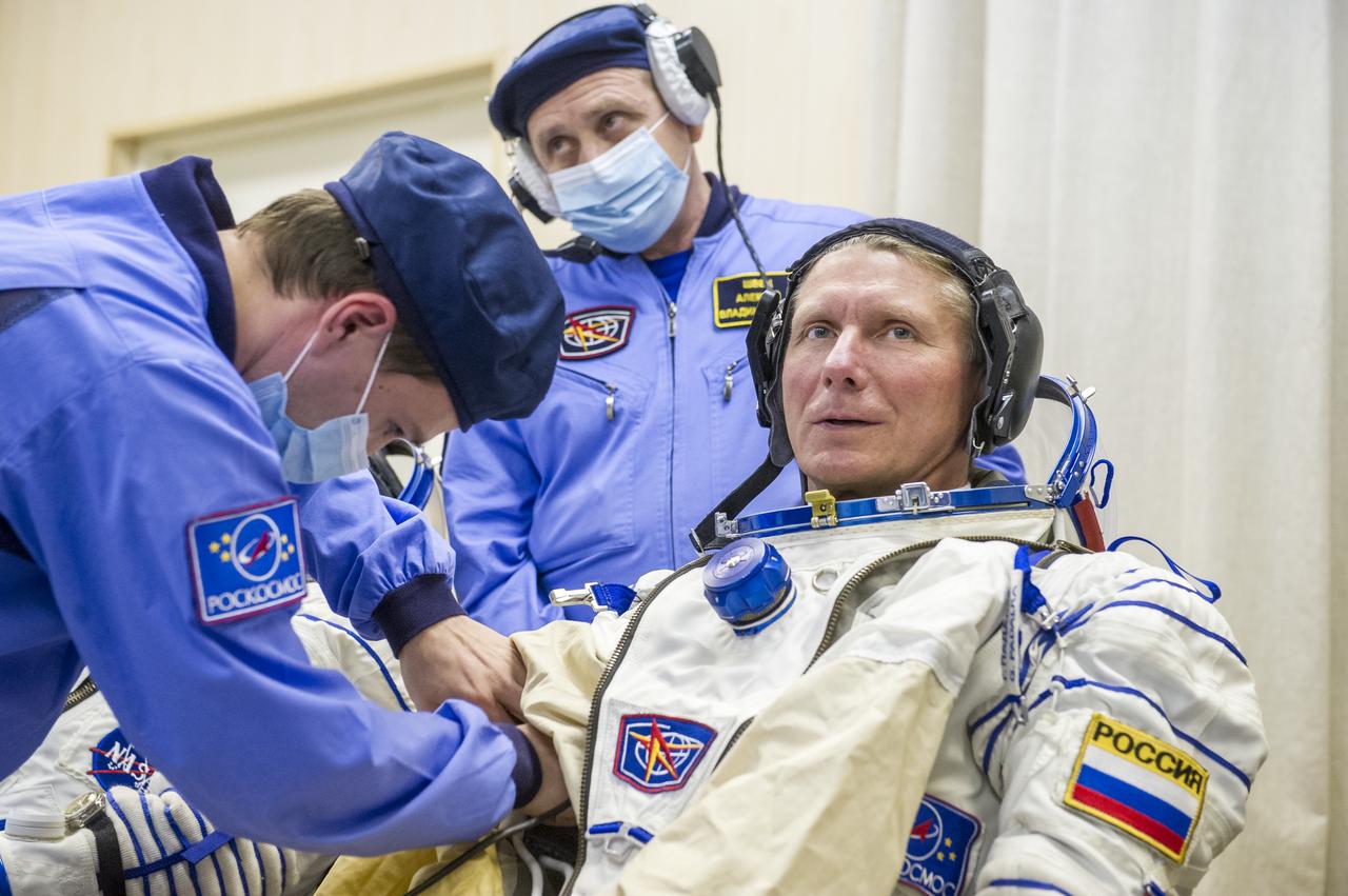 Expedition 43 Russian Cosmonaut Gennady Padalka of the Russian Federal Space Agency (Roscosmos) dons his Russian sokol suit ahead of his launch onboard the Soyuz TMA-16M spacecraft to the International Space Station with fellow crew mates, NASA Astronaut Scott Kelly, and Russian Cosmonaut Mikhail Kornienko Friday, March 27, 2015 in Baikonor, Kazakhstan. As the one-year crew, Kelly and Kornienko will return to Earth on Soyuz TMA-18M in March 2016.  Photo Credit: (NASA/GCTC/Andrey Shelepin)