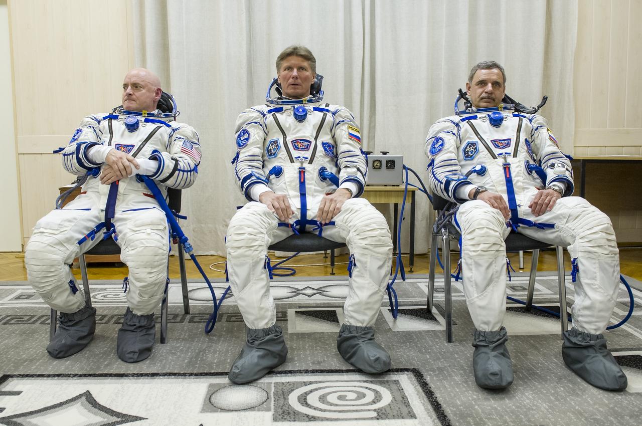 Expedition 43 NASA Astronaut Scott Kelly, left, Russian Cosmonauts Gennady Padalka, center, and Mikhail Kornienko of the Russian Federal Space Agency (Roscosmos) are seen shortly after having donned their Russian sokol suits for their launch onboard the Soyuz TMA-16M spacecraft to the International Space Station, Friday, March 27, 2015 in Baikonor, Kazakhstan. Kelly, Padalka, and Kornienko launched to the ISS from the Baikonur Cosmodrome in Kazakhstan March 28, Kazakh time (March 27 Eastern time.) As the one-year crew, Kelly and Kornienko will return to Earth on Soyuz TMA-18M in March 2016.  Photo Credit: (NASA/GCTC/Andrey Shelepin)