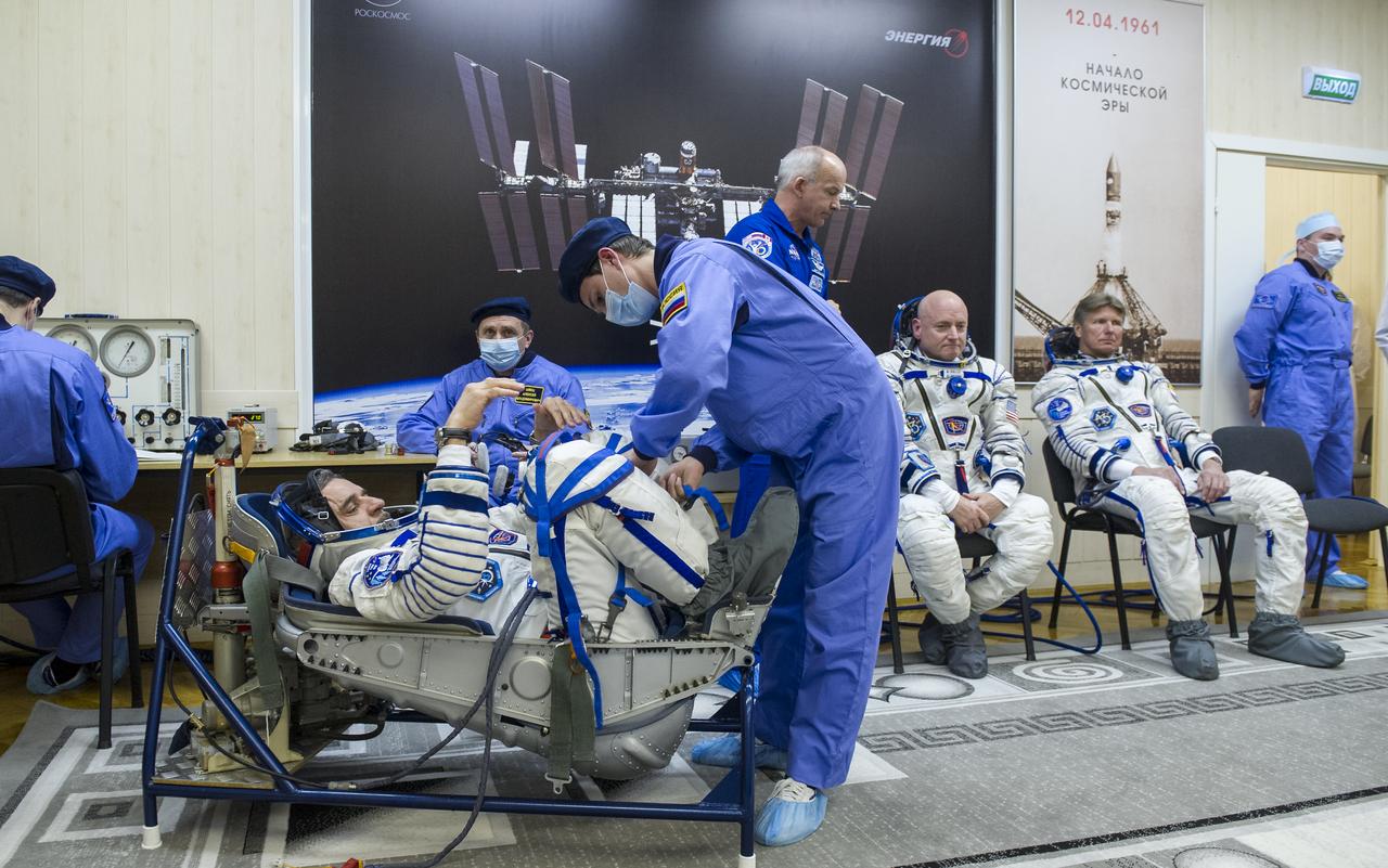 Expedition 43 Russian Cosmonaut Mikhail Kornienko of the Russian Federal Space Agency (Roscosmos), left, NASA Astronaut Scott Kelly, center, and Russian Cosmonaut Gennady Padalka all have their Russian sokol suits pressure checked for their launch onboard the Soyuz TMA-16M spacecraft to the International Space Station, Friday, March 27, 2015 in Baikonor, Kazakhstan. Kelly, Padalka, and Kornienko launched to the ISS from the Baikonur Cosmodrome in Kazakhstan March 28, Kazakh time (March 27 Eastern time.) As the one-year crew, Kelly and Kornienko will return to Earth on Soyuz TMA-18M in March 2016.  Photo Credit: (NASA/GCTC/Andrey Shelepin)