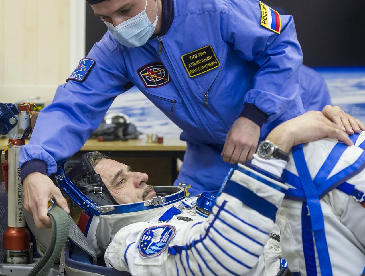 Expedition 43 Russian Cosmonaut Mikhail Kornienko of the Russian Federal Space Agency (Roscosmos) prepares to have his Russian sokol suit pressure checked ahead of his launch onboard the Soyuz TMA-16M spacecraft to the International Space Station with fellow crew mates NASA Astronaut Scott Kelly, center, and Russian Cosmonaut Gennady Padalka Friday, March 27, 2015 in Baikonor, Kazakhstan. Kelly, Padalka, and Kornienko launched to the ISS from the Baikonur Cosmodrome in Kazakhstan March 28, Kazakh time (March 27 Eastern time.) As the one-year crew, Kelly and Kornienko will return to Earth on Soyuz TMA-18M in March 2016.  Photo Credit: (NASA/GCTC/Andrey Shelepin)
