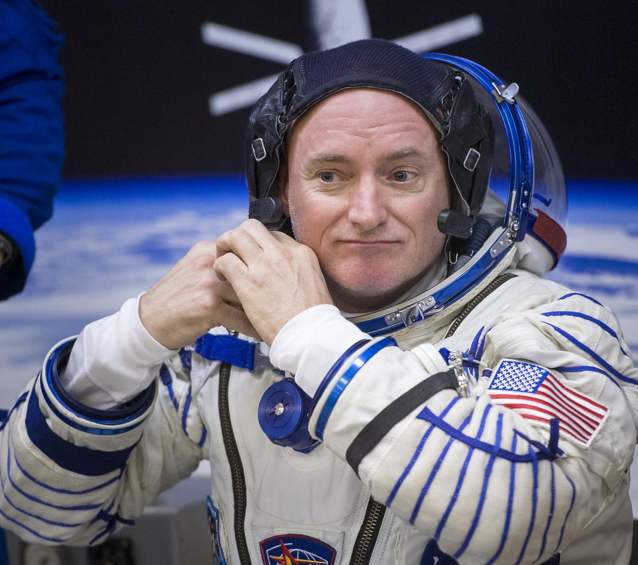 Expedition 43 NASA Astronaut Scott Kelly adjust his cap as he and his fellow crew members, Russian Cosmonauts Gennady Padalka, and Mikhail Kornienko of the Russian Federal Space Agency (Roscosmos) have their Russian sokol suits pressure checked ahead of their launch onboard the Soyuz TMA-16M spacecraft to the International Space Station Friday, March 27, 2015 in Baikonor, Kazakhstan. Kelly, Padalka, and Kornienko launched to the ISS from the Baikonur Cosmodrome in Kazakhstan March 28, Kazakh time (March 27 Eastern time.) As the one-year crew, Kelly and Kornienko will return to Earth on Soyuz TMA-18M in March 2016. Photo Credit: (NASA/Bill Ingalls)
