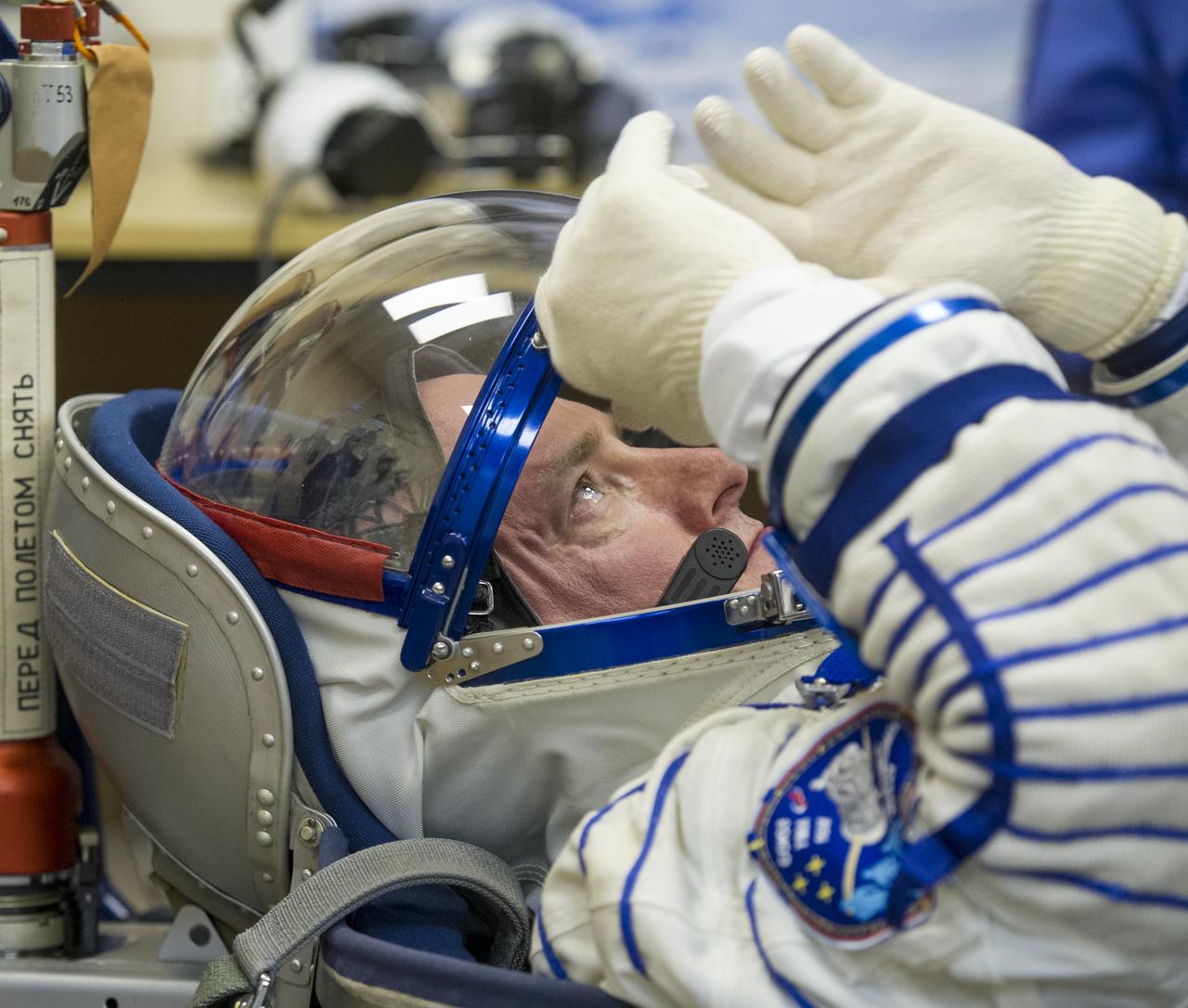 Expedition 43 NASA Astronaut Scott Kelly is seen as he and his fellow crew members, Russian Cosmonauts Gennady Padalka, and Mikhail Kornienko of the Russian Federal Space Agency (Roscosmos) have their Russian sokol suits pressure checked ahead of their launch onboard the Soyuz TMA-16M spacecraft to the International Space Station Friday, March 27, 2015 in Baikonor, Kazakhstan. Kelly, Padalka, and Kornienko launched to the ISS from the Baikonur Cosmodrome in Kazakhstan March 28, Kazakh time (March 27 Eastern time.) As the one-year crew, Kelly and Kornienko will return to Earth on Soyuz TMA-18M in March 2016. Photo Credit: (NASA/GCTC/Andrey Shelepin)