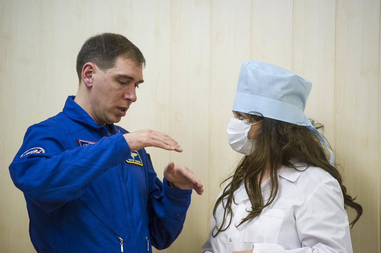 Expedition 43 backup crew member Sergei Volkov of Russia's Federal Space Agency (Roscosmos) explains the Russian sokol suit pressure check process to Soprano Singer Sarah Brightman, scheduled to fly to space later in 2015 as a spaceflight participant, while  NASA Astronaut Scott Kelly, Russian Cosmonauts Gennady Padalka, and Mikhail Kornienko of the Russian Federal Space Agency (Roscosmos) have their Russian sokol suits pressure checked ahead of their launch onboard the Soyuz TMA-16M spacecraft to the International Space Station Friday, March 27, 2015 in Baikonor, Kazakhstan. Kelly, Padalka, and Kornienko launched to the ISS from the Baikonur Cosmodrome in Kazakhstan March 28, Kazakh time (March 27 Eastern time.) As the one-year crew, Kelly and Kornienko will return to Earth on Soyuz TMA-18M in March 2016.  Photo Credit: (NASA/GCTC/Andrey Shelepin)