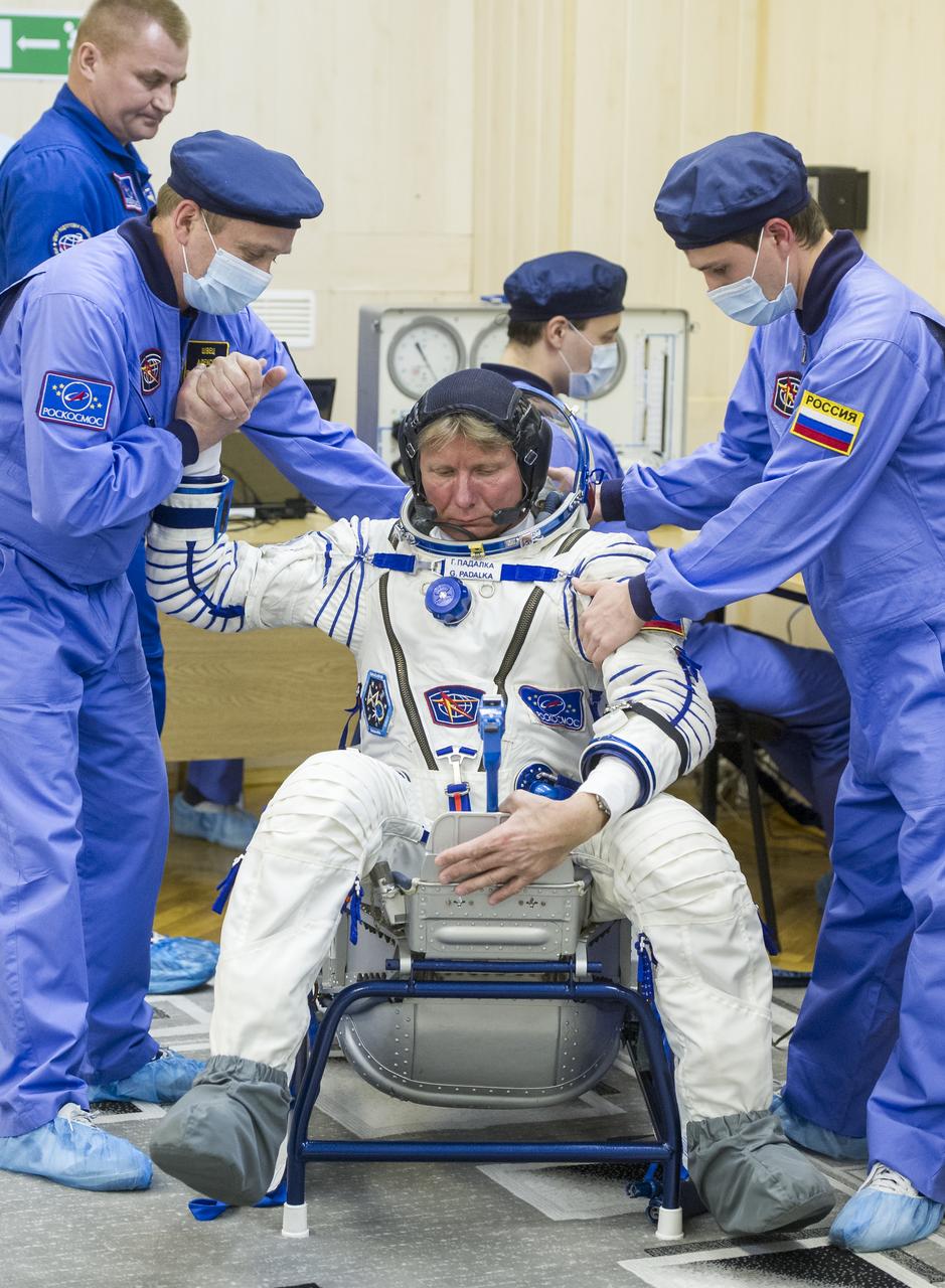 Expedition 43 Russian Cosmonaut Gennady Padalka, of the Russian Federal Space Agency (Roscosmos) sits down to have his Russian sokol suit pressure checked ahead of his launch onboard the Soyuz TMA-16M spacecraft to the International Space Station with fellow crew members NASA Astronaut Scott Kelly, and Russian Cosmonaut Mikhail Kornienko Friday, March 27, 2015 in Baikonor, Kazakhstan. Kelly, Padalka, and Kornienko launched to the ISS from the Baikonur Cosmodrome in Kazakhstan March 28, Kazakh time (March 27 Eastern time.) As the one-year crew, Kelly and Kornienko will return to Earth on Soyuz TMA-18M in March 2016. Photo Credit: (NASA/GCTC/Andrey Shelepin)