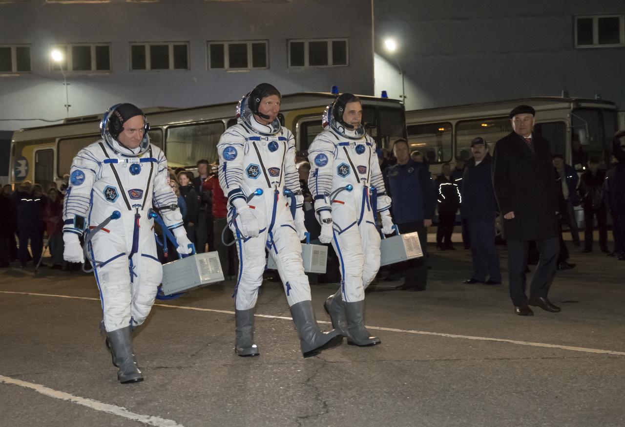 Expedition 43 NASA Astronaut Scott Kelly, left, and Russian Cosmonauts Gennady Padalka, center, and Mikhail Kornienko of the Russian Federal Space Agency (Roscosmos) depart building 254 for their launch onboard the Soyuz TMA-16M spacecraft to the International Space Station Friday, March 27, 2015 in Baikonor, Kazakhstan. Kelly, Padalka, and Kornienko launched to the ISS from the Baikonur Cosmodrome in Kazakhstan March 28, Kazakh time (March 27 Eastern time.) As the one-year crew, Kelly and Kornienko will return to Earth on Soyuz TMA-18M in March 2016.  Photo Credit: (NASA/Victor Zelentsov)