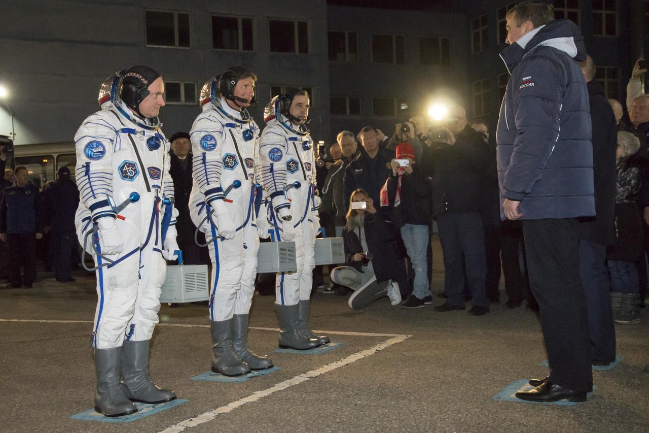 Expedition 43 NASA Astronaut Scott Kelly, left, and Russian Cosmonauts Gennady Padalka, center, and Mikhail Kornienko of the Russian Federal Space Agency (Roscosmos) wait to receive a final salute from officials before departing building 254 for their launch onboard the Soyuz TMA-16M spacecraft to the International Space Station Friday, March 27, 2015 in Baikonor, Kazakhstan. Kelly, Padalka, and Kornienko launched to the ISS from the Baikonur Cosmodrome in Kazakhstan March 28, Kazakh time (March 27 Eastern time.) As the one-year crew, Kelly and Kornienko will return to Earth on Soyuz TMA-18M in March 2016.  Photo Credit: (NASA/Victor Zelentsov)