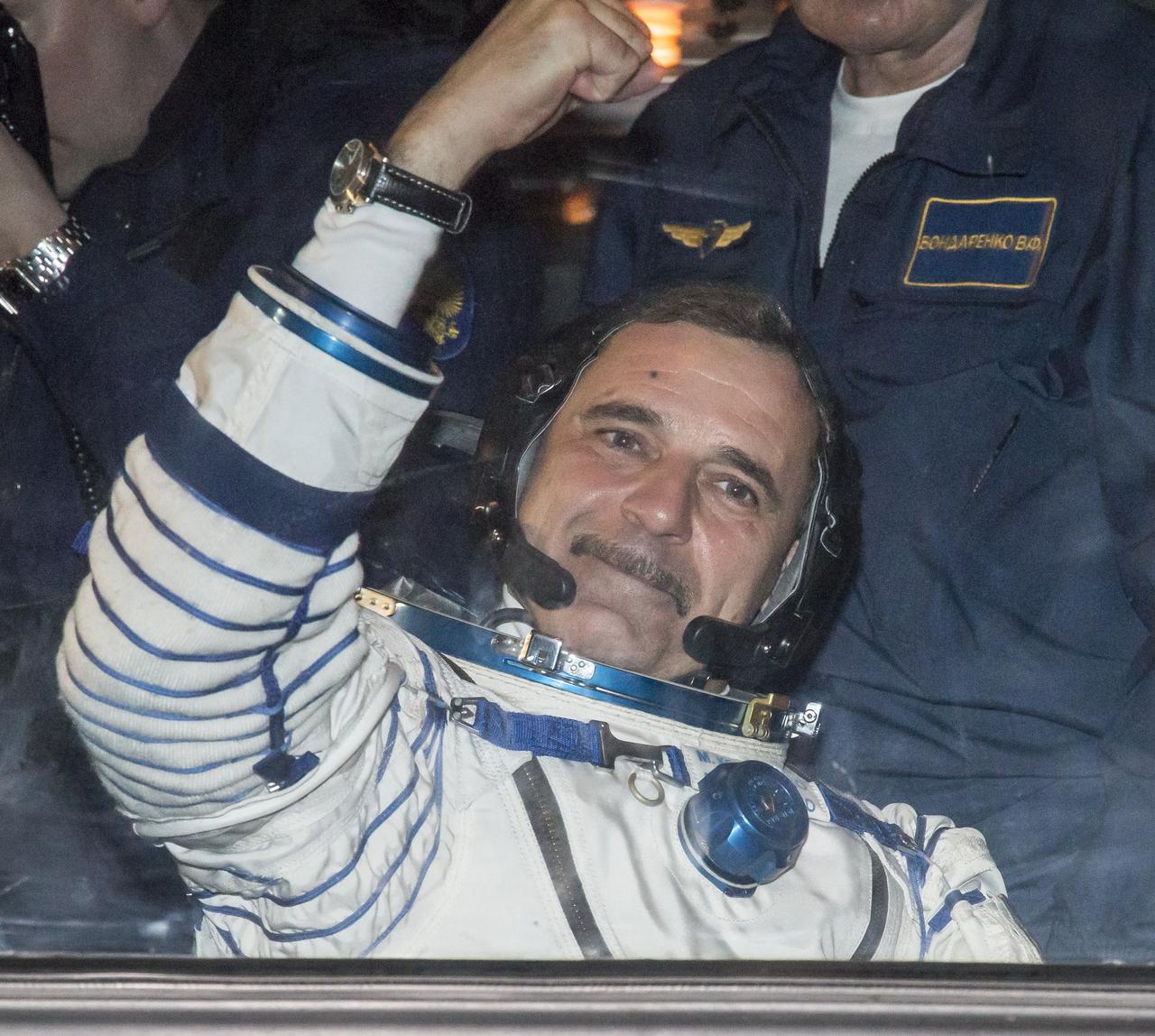 Expedition 43 Russian Cosmonaut Mikhail Kornienko of the Russian Federal Space Agency (Roscosmos) waves farewell to family and friends as he and fellow crew members NASA Astronaut Scott Kelly, and Russian Cosmonaut Gennady Padalka depart building 254 for their launch onboard the Soyuz TMA-16M spacecraft to the International Space Station Friday, March 27, 2015 in Baikonor, Kazakhstan. Kelly, Padalka, and Kornienko launched to the ISS from the Baikonur Cosmodrome in Kazakhstan March 28, Kazakh time (March 27 Eastern time.) As the one-year crew, Kelly and Kornienko will return to Earth on Soyuz TMA-18M in March 2016.  Photo Credit: (NASA/Victor Zelentsov)
