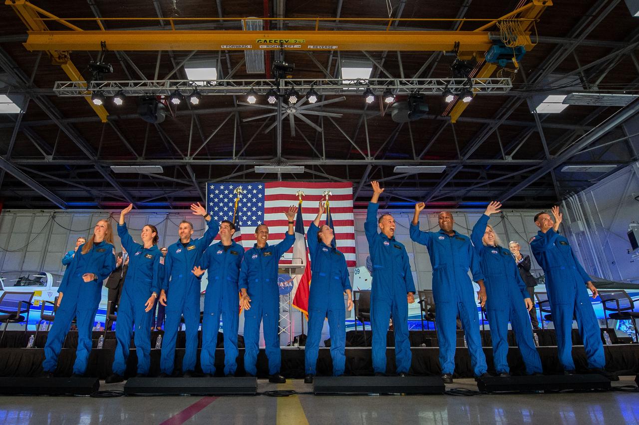Photo Date: 2021-12-06 NASA announced its 2021 astronaut candidate class on Dec. 6, 2021. The 10 candidates, pictured here in an event at Ellington Field near NASA’s Johnson Space Center in Houston are Nichole Ayers, Christopher Williams, Luke Delaney, Jessica Wittner, Anil Menon, Marcos BerrÃos, Jack Hathaway, Christina Birch, Deniz Burnham, and Andre Douglas. NASA’s new astronaut candidates will begin about two years of training in January 2022, after which they could be assigned to missions performing research on the International Space Station, launching from American soil on spacecraft built by commercial companies, and launching on Artemis missions to the Moon on NASA’s new Orion spacecraft and Space Launch System rocket. Location: Ellington Hangar 135 Photographer: James Blair