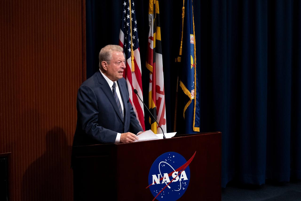 To commemorate the upcoming 10th anniversary of the DSCOVR (Deep Space Climate Observatory) mission, NASA’s Goddard Space Flight Center in Greenbelt, Md., hosted environmentalist and former Vice President Al Gore, shown here addressing a crowd in the Building 3 Harry J. Goett Auditorium, on Oct. 16, 2024.  “The image of our Earth from space is the single most compelling iconic image that any of us have ever seen,” Gore said at a panel discussion for employees. “Now we have, thanks to DSCOVR, 50,000 ‘Blue Marble’ photographs … To date there are more than 100 peer-reviewed scientific publications that are based on the unique science gathered at the L1 point by DSCOVR. For all of the scientists who are here and those on the teams that are represented here, I want to say congratulations and thank you.”  Following Gore’s talk on climate monitoring, Goddard scientists participated in a panel discussion, “Remote Sensing and the Future of Earth Observations,” which explored the latest advancements in technology that allow for the monitoring of the atmosphere from space and showcased how Goddard’s research drives the future of Earth science.  Gore’s visit also entailed a meeting with the DSCOVR science team, a view into the clean room where Goddard is assembling the Roman Space Telescope, and a stop at the control center for PACE: NASA’s Plankton, Aerosol, Cloud, ocean Ecosystem mission.  Launched Feb. 11, 2015, DSCOVR is a space weather station that monitors changes in the solar wind, providing space weather alerts and forecasts for geomagnetic storms that could disrupt power grids, satellites, telecommunications, aviation and GPS.  DSCOVR is a joint mission among NASA, the National Oceanic and Atmospheric Administration (NOAA), and the U.S. Air Force. The project originally was called Triana, a mission conceived of by Gore in 1998 during his vice presidency.