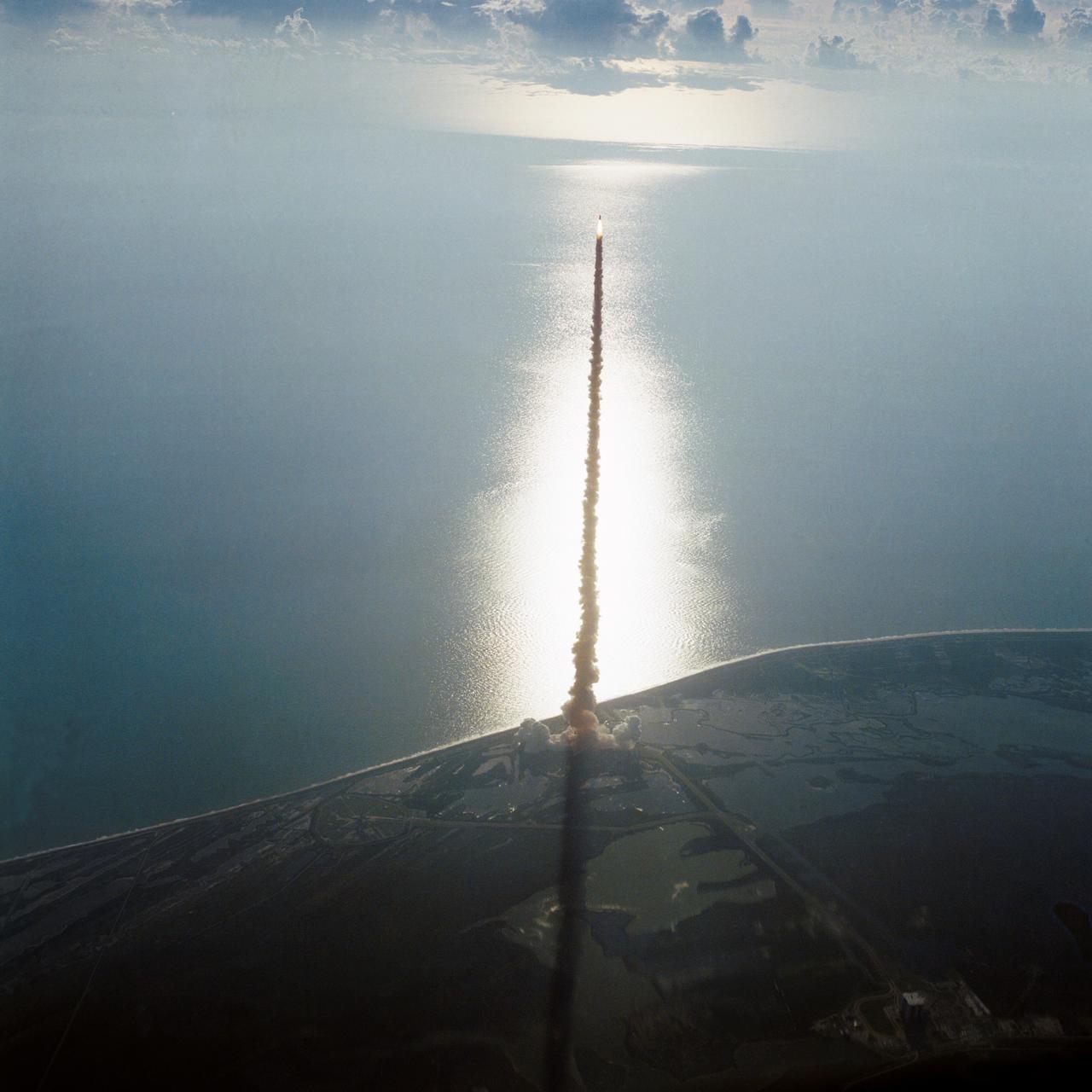 41D-3063 (30 Aug. 1984) --- The space shuttle Discovery climbs toward Earth orbit following a successful liftoff from KSC's Pad 39A at 8:41:50 a.m. (EDT), Aug. 30, 1984. Inside the spacecraft are six crewmembers looking forward to a busy week in space. The scene was photographed by astronaut John W. Young in the Shuttle Training Aircraft (STA). Photo credit: NASA
