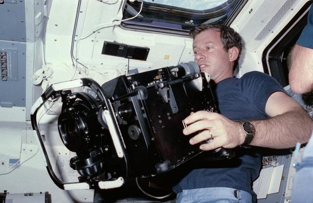 NASA image: Astronaut Terry Hart prepares to use IMAX camera