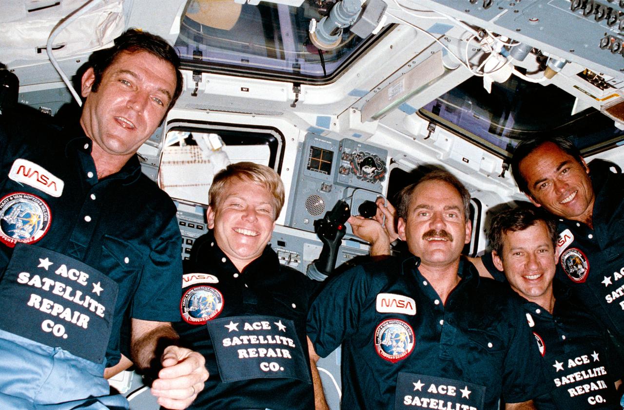 41C-07-262 (6-13 April 1984) --- Automatic exposure on a stationary 35mm camera recorded this "team" photograph of the 41-C astronauts at the aft flight deck of the Earth orbiting Challenger.  Astronauts Robert L. Crippen, right, crew commander; and Francis R. (Dick) Scobee, left, pilot, flank the mission specialists--(l-r) George D. Nelson, James D. van Hoften and Terry J. Hart.  This picture was among 20 frames of 41-C photography released by NASA on the weekend following the April 13 landing at Edwards Air Force Base and it was used as one of the visuals at the April 24 post-flight press conference. .
