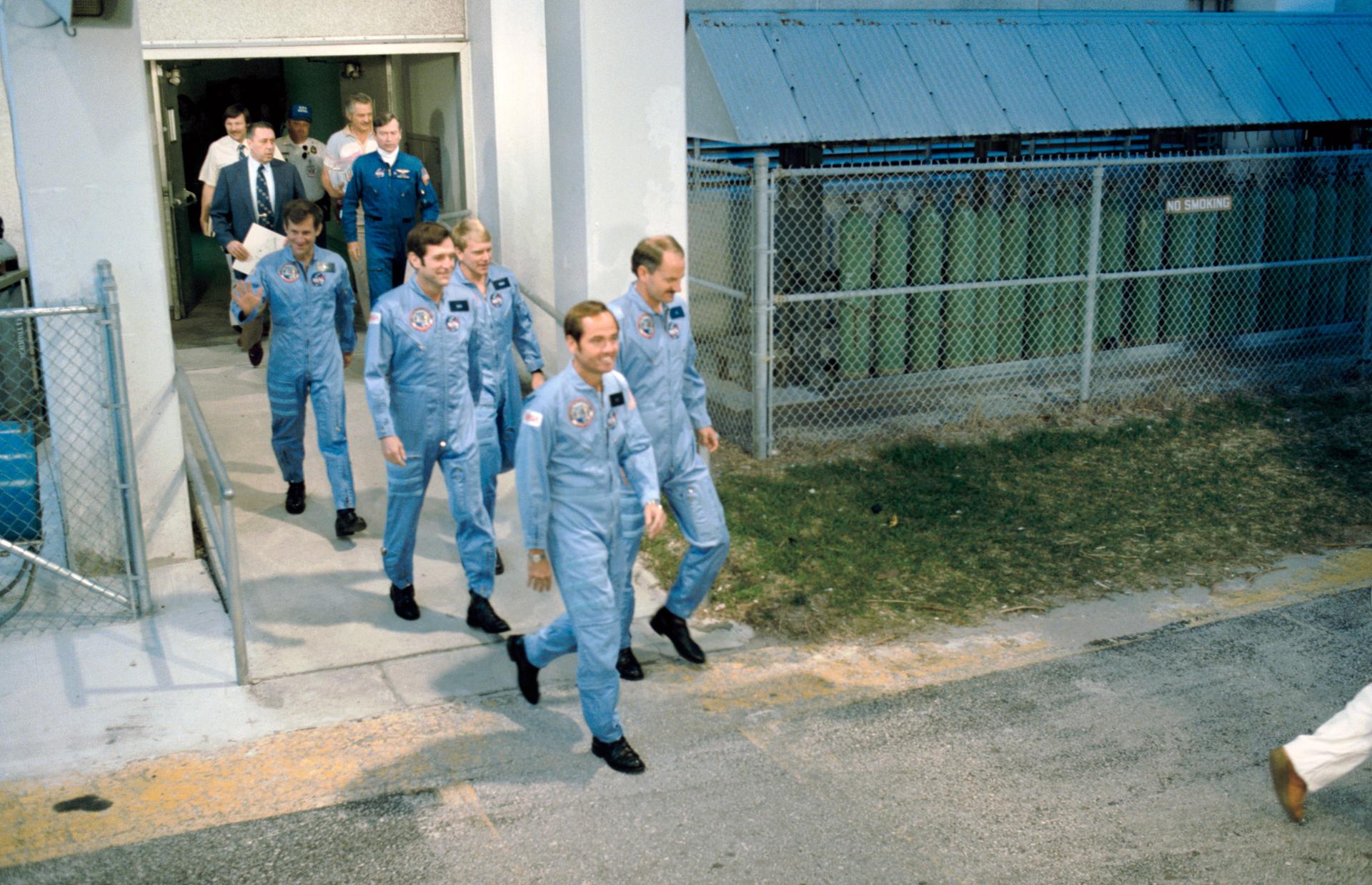 The STS-41C crew walk out to the transfer van at Kennedy Space Center
