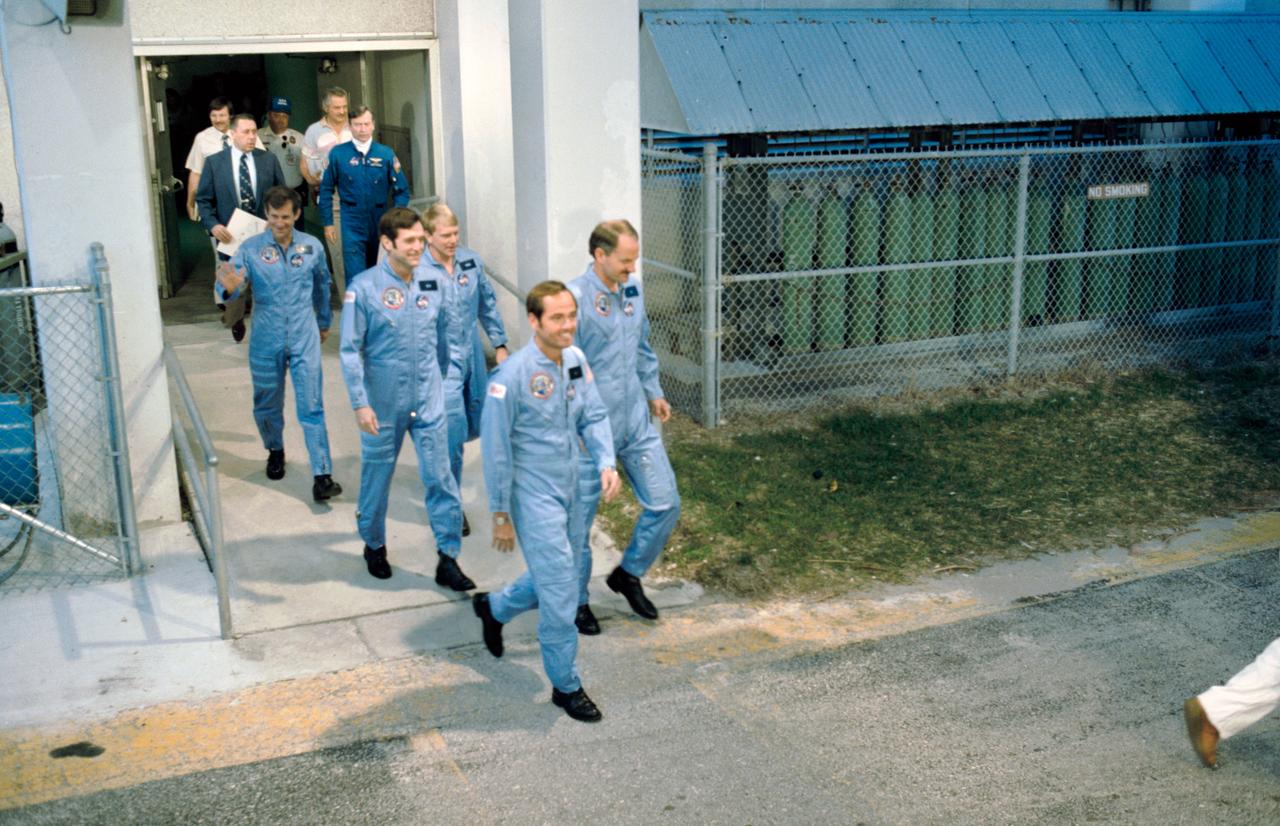 41C-3061 (6 April 1984) --- The five-member astronauts crew for NASA's STS-41C Space Shuttle mission head for the transfer van that will transport them to Launch Pad 39B at the Kennedy Space Center.  Astronaut Robert L. Crippen, commander, leads the way.  Immediately behind Crippen is Astronaut Francis R. (Dick) Scobee, pilot.  The three mission specialists are (left to right) Astronauts Terry J. Hart, George D. Nelson and James D. van Hoften.  The photograph was taken by Otis Imobden.