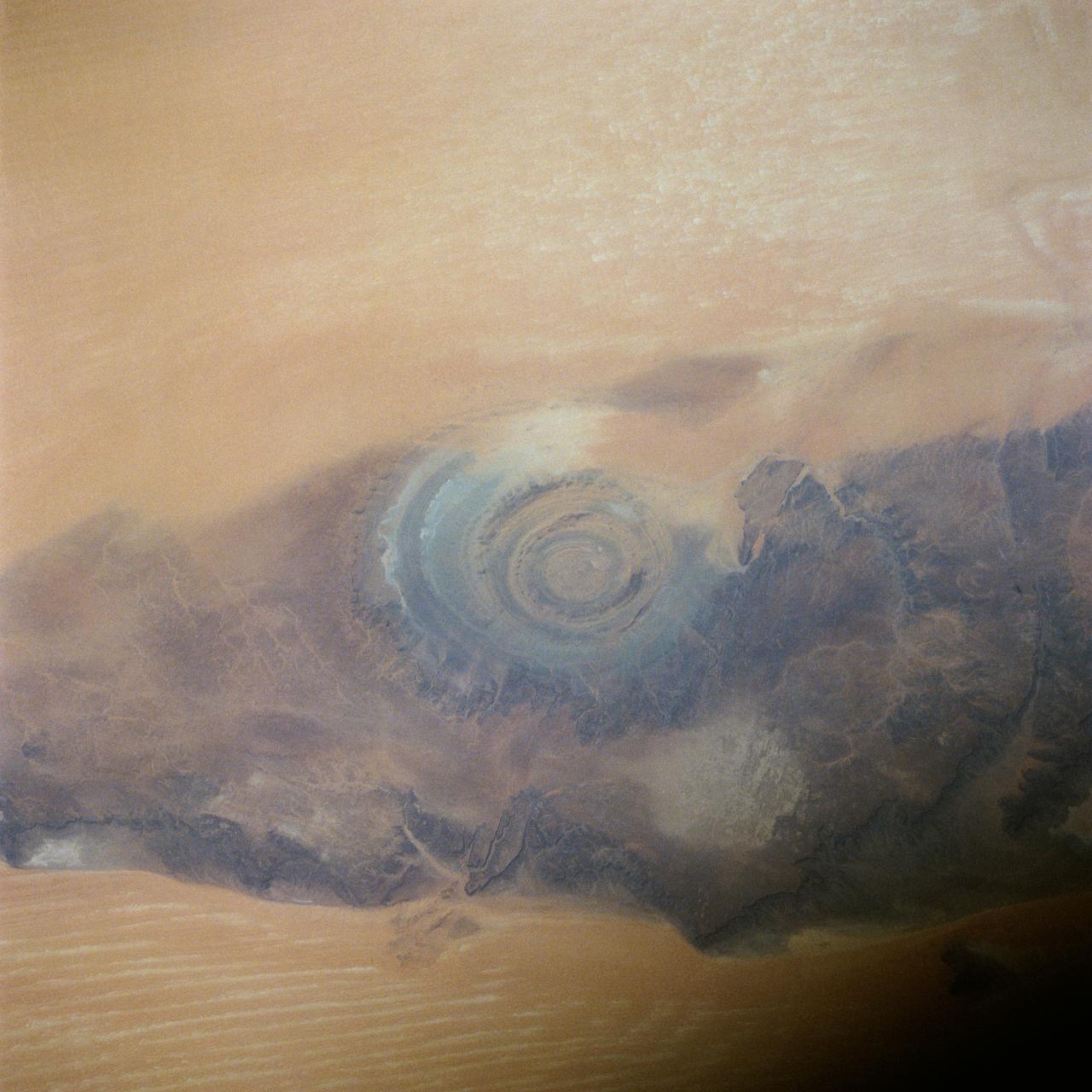 41C-39-1973 (6-13 April 1984) --- Though photographed on previous manned spaceflights, the Richat Structure in Western Mauritania has seldom if ever been able to be seen more clearly and studied more completely than in this 41-C 70mm frame, according to geologists.  The structure is actually a 25-mile wide, 1,000-ft. deep hole in the Earth, the result of heavy wind erosion.  This frame was one of the visuals used by the 41-C astronauts at their April 24, 1984 post-flight press conference.
