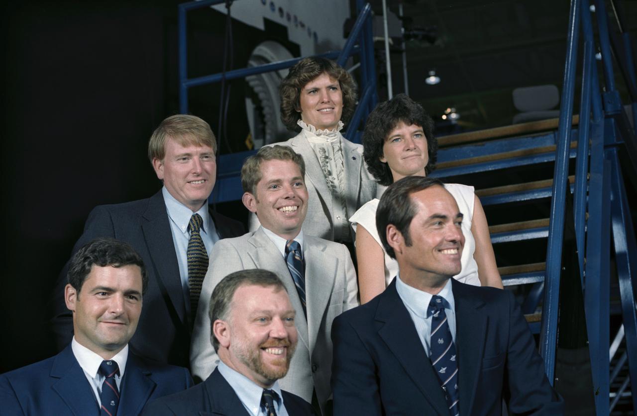 41D-3277 (S14-3277) (4 Sept 1984) --- Having met the press for the first time as a group, members of the STS 41-G crew pose for photographs in the Shuttle mockup and   integration laboratory at the Johnson Space   Center.  They are (bottom row, left, to right)   Marc Garneau and Paul D.  Scully-Power, both   payload specialists; and Robert L. Crippen, crew commander; (second row, l.-r.) Astronauts Jon A. McBride, pilot; David C. Leestma and Sally K. Ride, both mission specialists; and Kathryn D. Sullivan, mission specialist.  They are scheduled for an October 5, 1984 launch aboard the Space Shuttle Challenger.