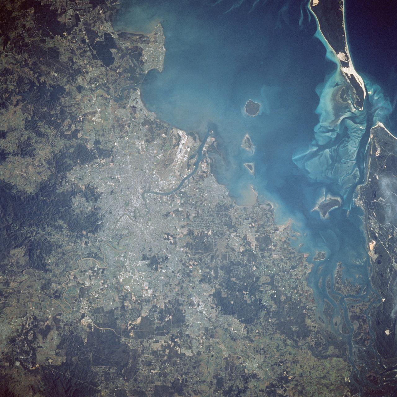 41D-41-062 (30 Aug-5 Sept 1984) --- An example of the surface details on the Earth seen by orbiting astronauts is provided by this Hasselblad 500 EL/M photograph made with a 250mm lens over Brisbane, Australia. Urban areas and the airport complex lie along the Brisbane River which empties into Moreton Bay. The photograph was shown during the STS-41D postflight press conference held on September 12, 1984.