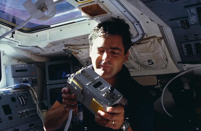 NASA image: Payload specialist Garneau displays Sunphotometer