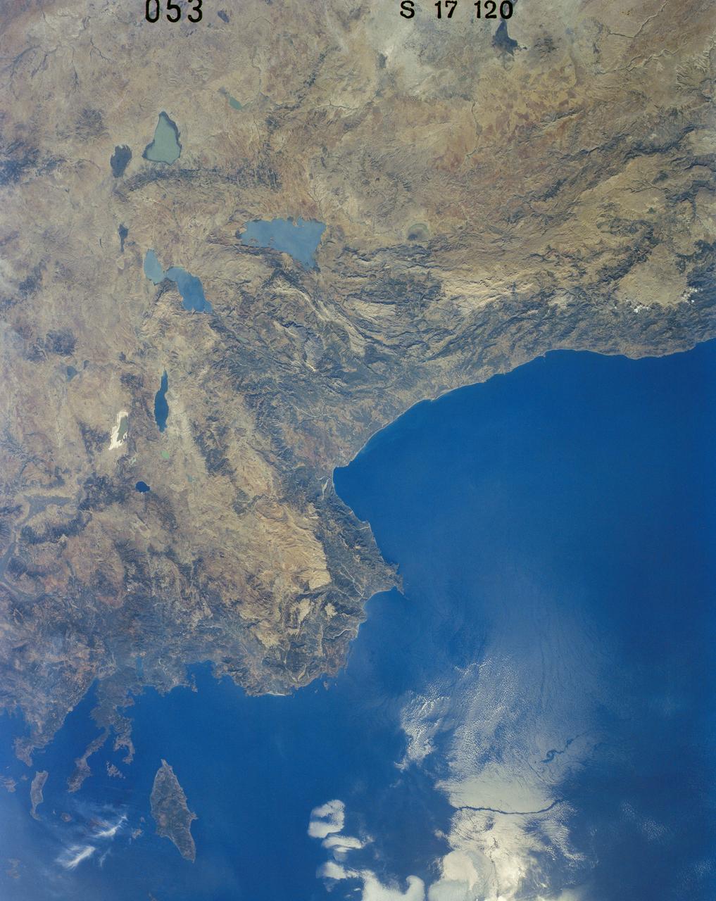 41G-120-053 (5-13 Oct. 1984) --- Turkey and a portion of the Mediterranean Sea, with the city of Antalya visible, were photographed with a medium format camera during the 41-G mission aboard the space shuttle Challenger. Numerous eddies and an ocean front can be observed in the sun's glint off the water's surface.  The folded mountains indicate the rugged topography in this region. Photo credit: NASA