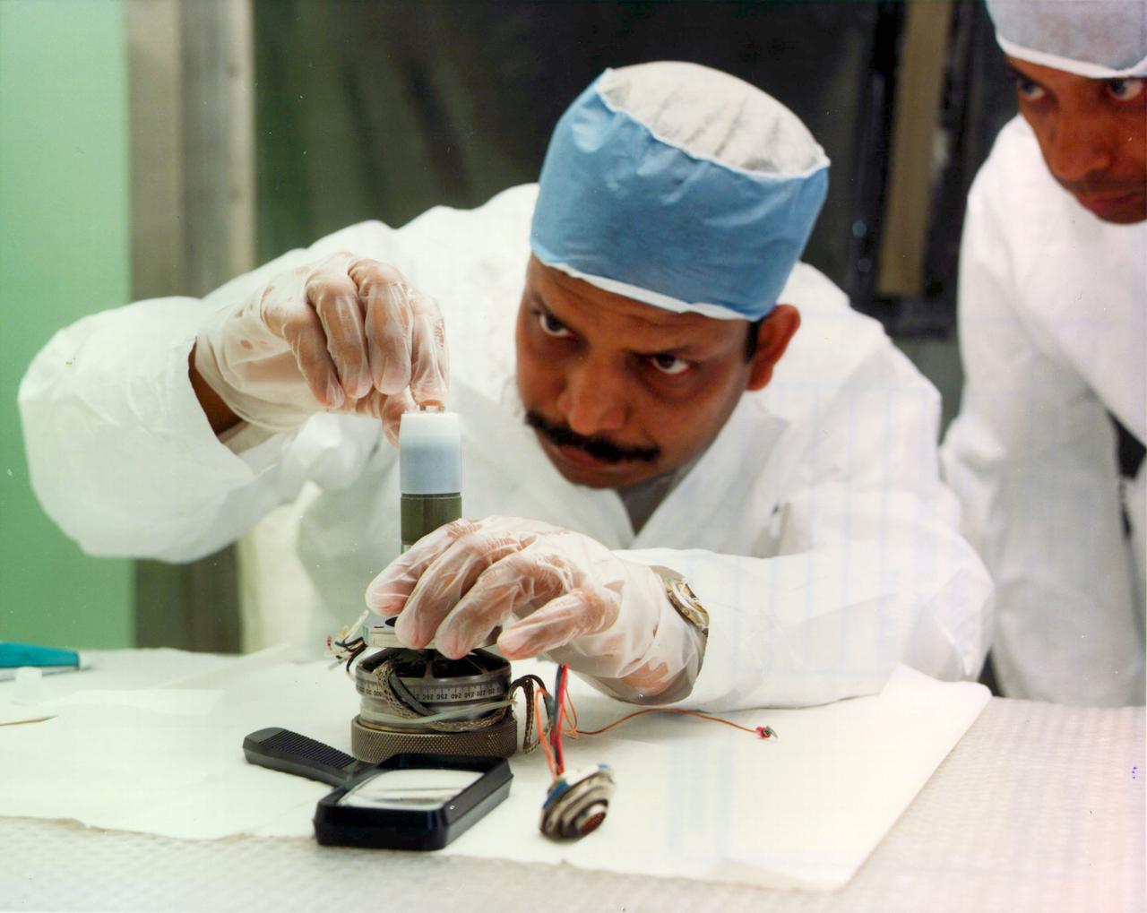 Dr. Aggarwal installing a flight seed in the Fluid Experiment System.