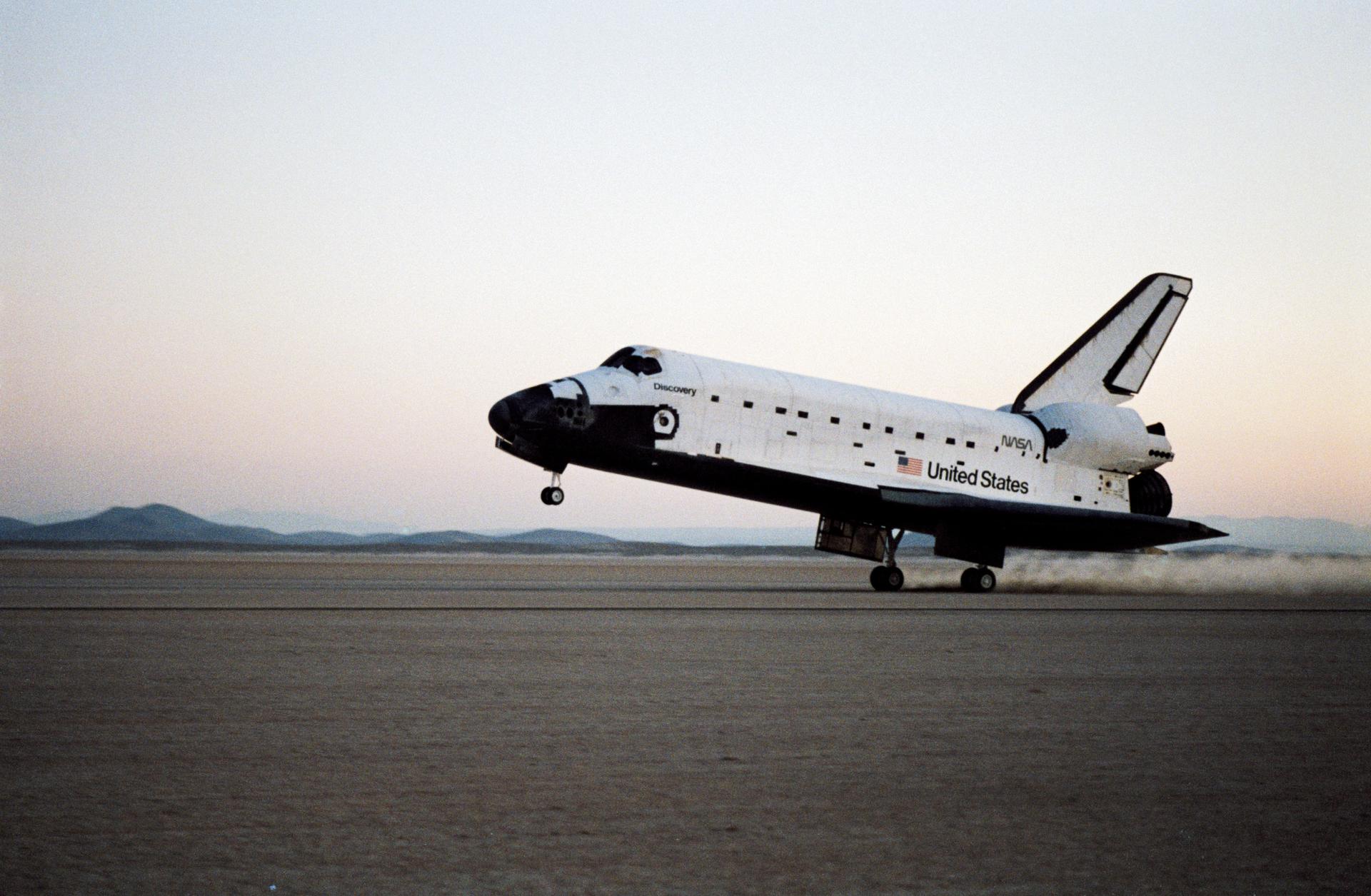 Space Shuttle Discovery lands at 6:16 p.m. local time at Edwards Air Force Base in California.