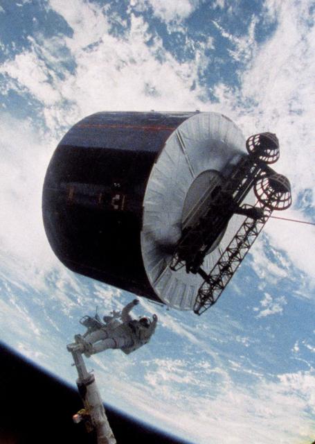 NASA image: Astronaut James van Hoften working with Syncom IV-3 satellite