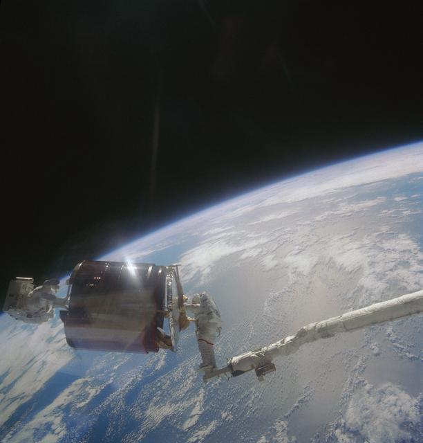NASA image: Astronauts Gardner and Allen bringing Westar VI satellite into payload bay