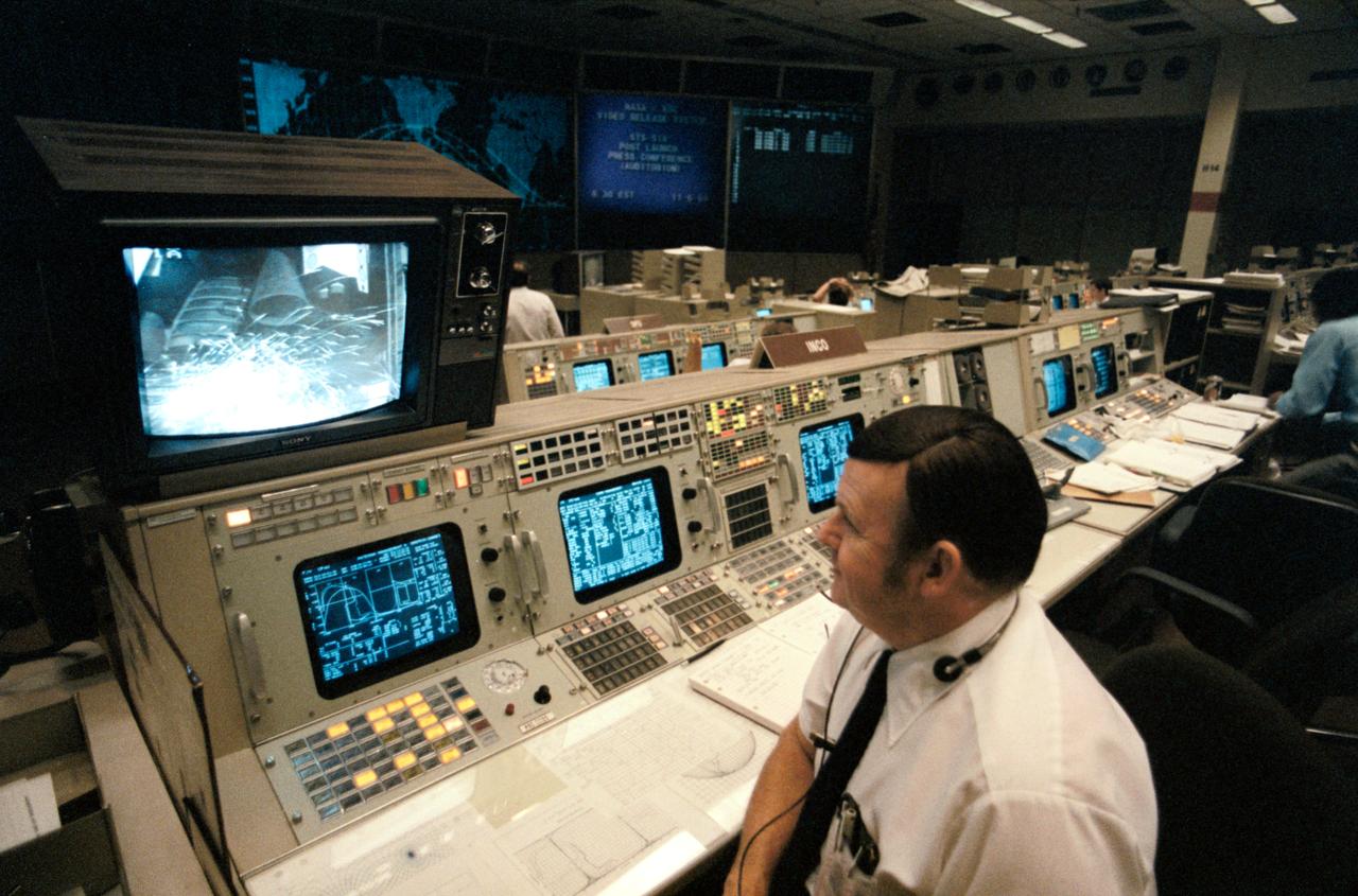 51A-90016 (8 Nov 1984) --- J. E. Conner, on duty at the integrated communcations officer console in the second floor Flight Control Room (FCR) of the Johnson Space Center's (JSC) Mission Control Center (MCC), watches engine ignition of Discovery on a nearby TV monitor.  Moments later, the Houston FCR took over control of the scheduled eight day mission 51-A.