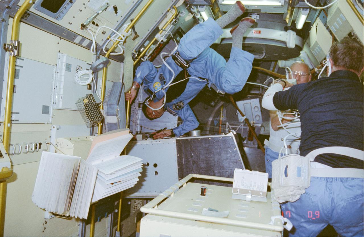 51B-03-035 (29 April-6 May 1985) --- Payload specialist Taylor G. Wang performs a repair task on the Drop Dynamics Module (DDM) in the Science Module aboard the Earth-orbiting Space Shuttle Challenger.  The photo was taken with a 35mm camera.  Dr. Wang is principal investigator for the first time-to-fly experiment, developed by his team at NASA?s Jet Propulsion Laboratory (JPL), Pasadena, California.  This photo was among the first to be released by NASA upon return to Earth by the Spacelab 3 crew.