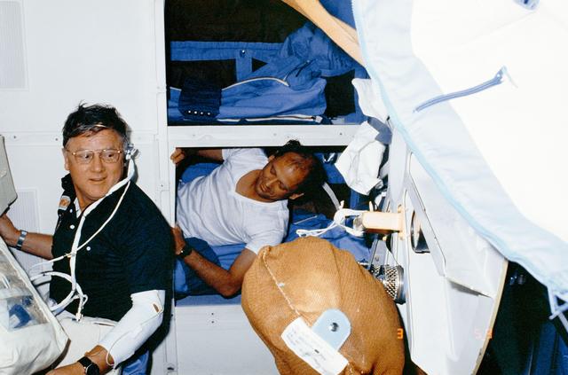NASA image: Astronaut Norman Thagard rests on middeck while other team is on duty