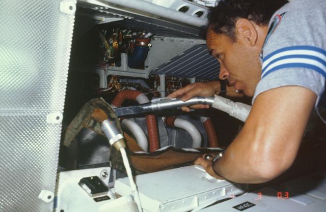 NASA image: Astronaut Frederick Gregory vacuums air filters in avionics bay