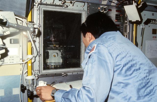 NASA image: Taylor E. Wang observes growth of crystals in VCGS aboard orbiter
