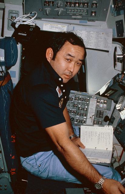 NASA image: Mission Specialist Ellison Onizuka seated at commander's station