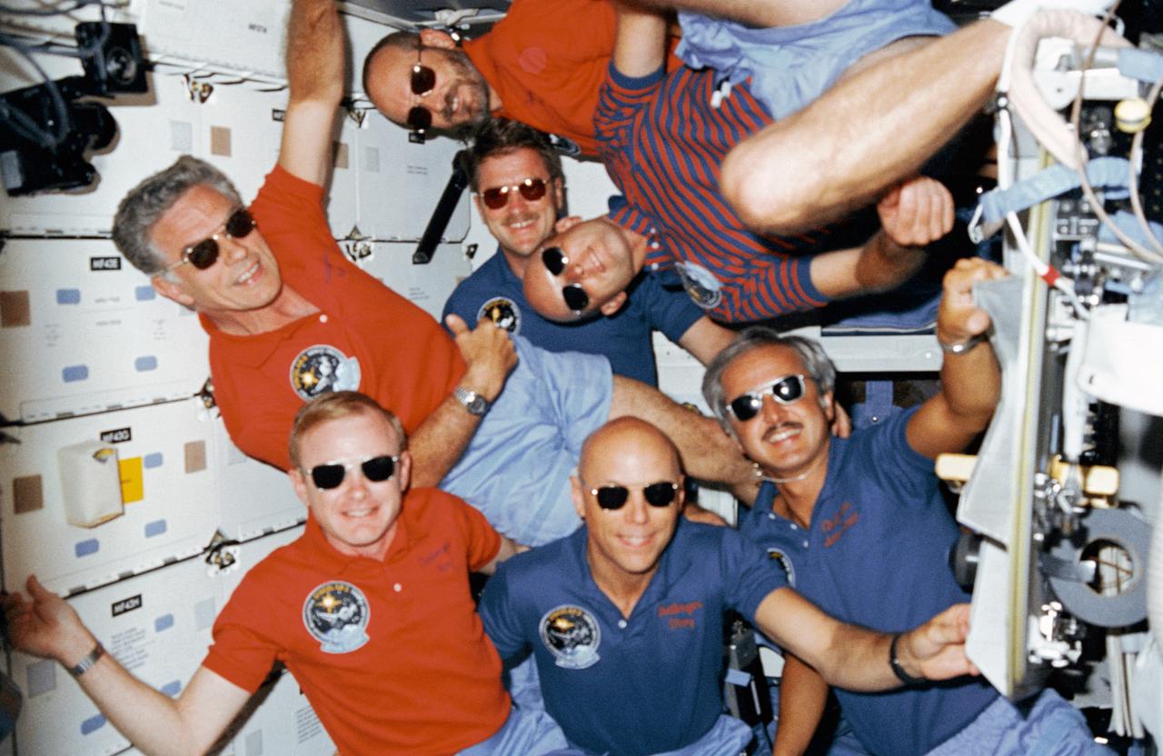 51F-06-017 (29 July-6 Aug. 1985) --- Crew portrait with sunglasses.  C. Gordon Fullerton's head is at center.  Others (bottom,  l.-r.) are Roy D. Bridges, F. Story Musgrave and John David Bartoe; and (top) Karl J. Henize, Loren W. Acton and Anthony W. England.