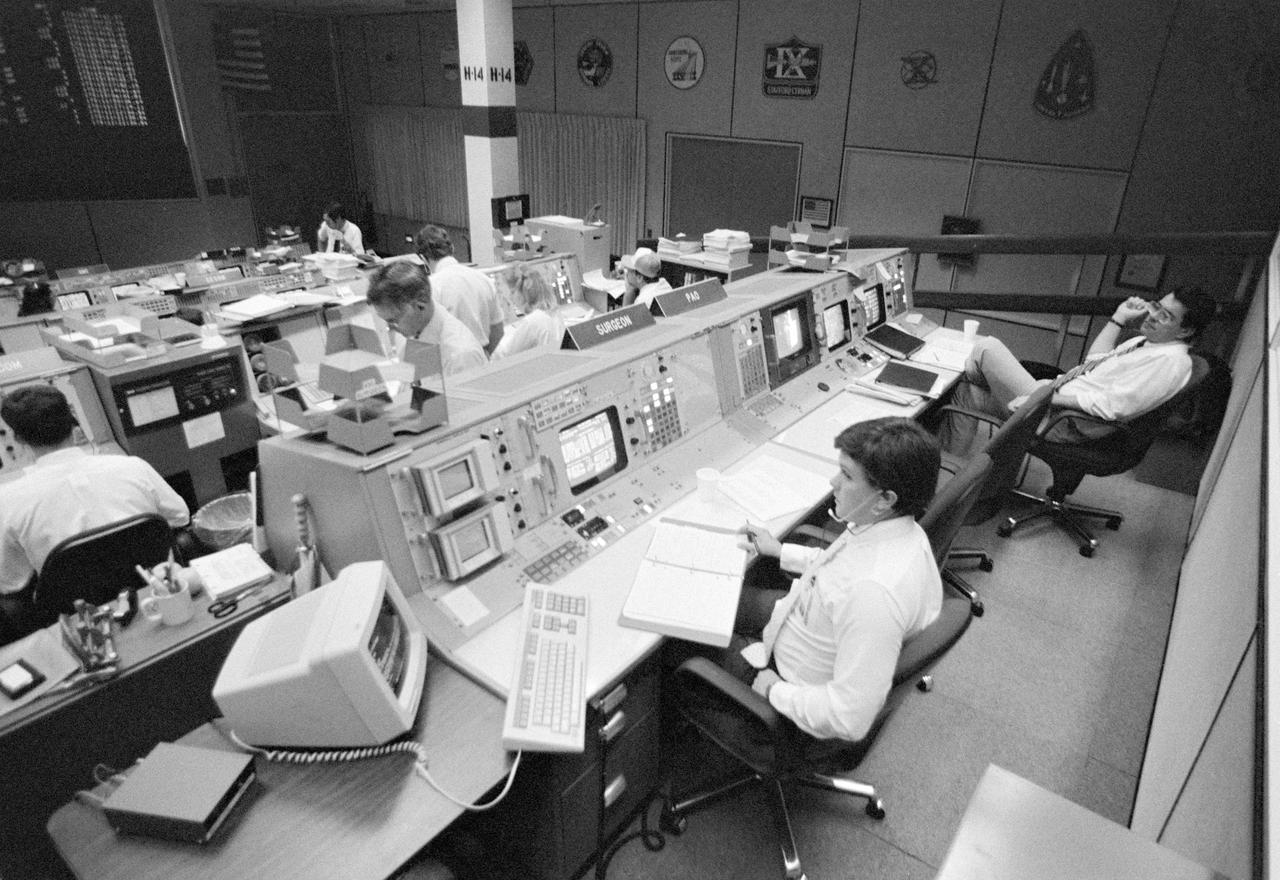 51G-S-204 (June 1985) --- Public Affairs Office (PAO) commentator John Lawrence (top right) is pictured at his console in the Mission Operations Control Room (MOCR) in the Mission Control Center at NASA's Johnson Space Center during the STS-51G mission. Photo credit: NASA